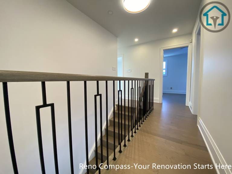 This image features a second-floor hallway renovation in Markham, completed by a Toronto Renovation Company, Reno Compass Inc. Light-toned hardwood flooring creates a clean and cohesive look, enhancing brightness and continuity throughout the upper level of the home.
