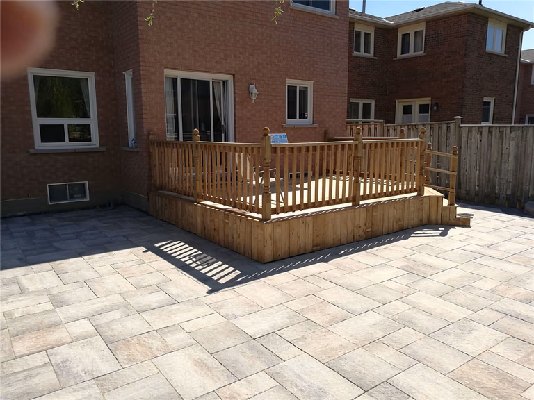This Richmond Hill landscaping renovation showcases a newly completed backyard patio with large-format interlocking stone installation. Designed for durability and modern outdoor living, the spacious patio features clean lines, contrasting border stones, and precise leveling for proper drainage. The upgraded hardscape creates a functional entertainment area perfect for family gatherings while enhancing the overall backyard layout and property value. Professional installation ensures long-lasting performance, weather resistance, and a refined outdoor finish suitable for all-season use in the GTA.