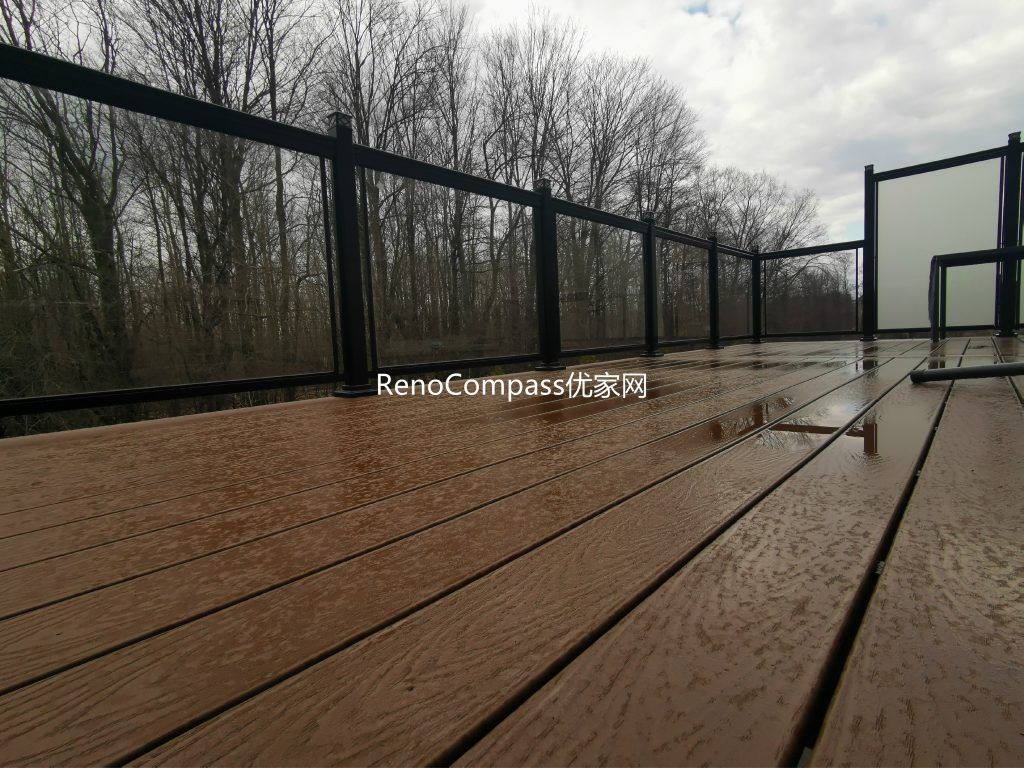 Professional deck construction project in Aurora featuring durable composite wood decking, modern black aluminum and glass railings, and a spacious outdoor layout. Designed for long-term durability and low maintenance, this backyard deck enhances outdoor comfort, safety, and property value.