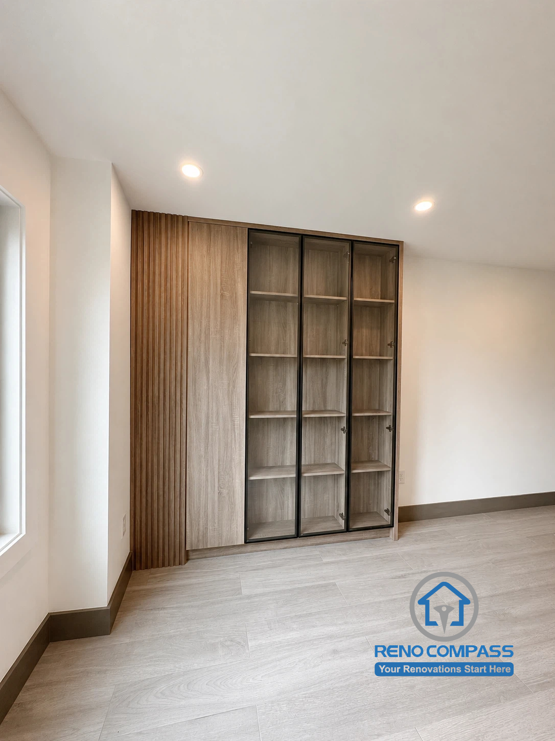 This custom open closet design features warm wood finishes, integrated storage solutions, and elegant glass display cabinets that bring both functionality and sophistication to the space. By replacing the traditional walk-in closet with an open-concept layout, the room feels brighter, more spacious, and better suited to modern living. Project completed by Reno Compass, serving Markham, Toronto, Richmond Hill, Vaughan, and the Greater Toronto Area.