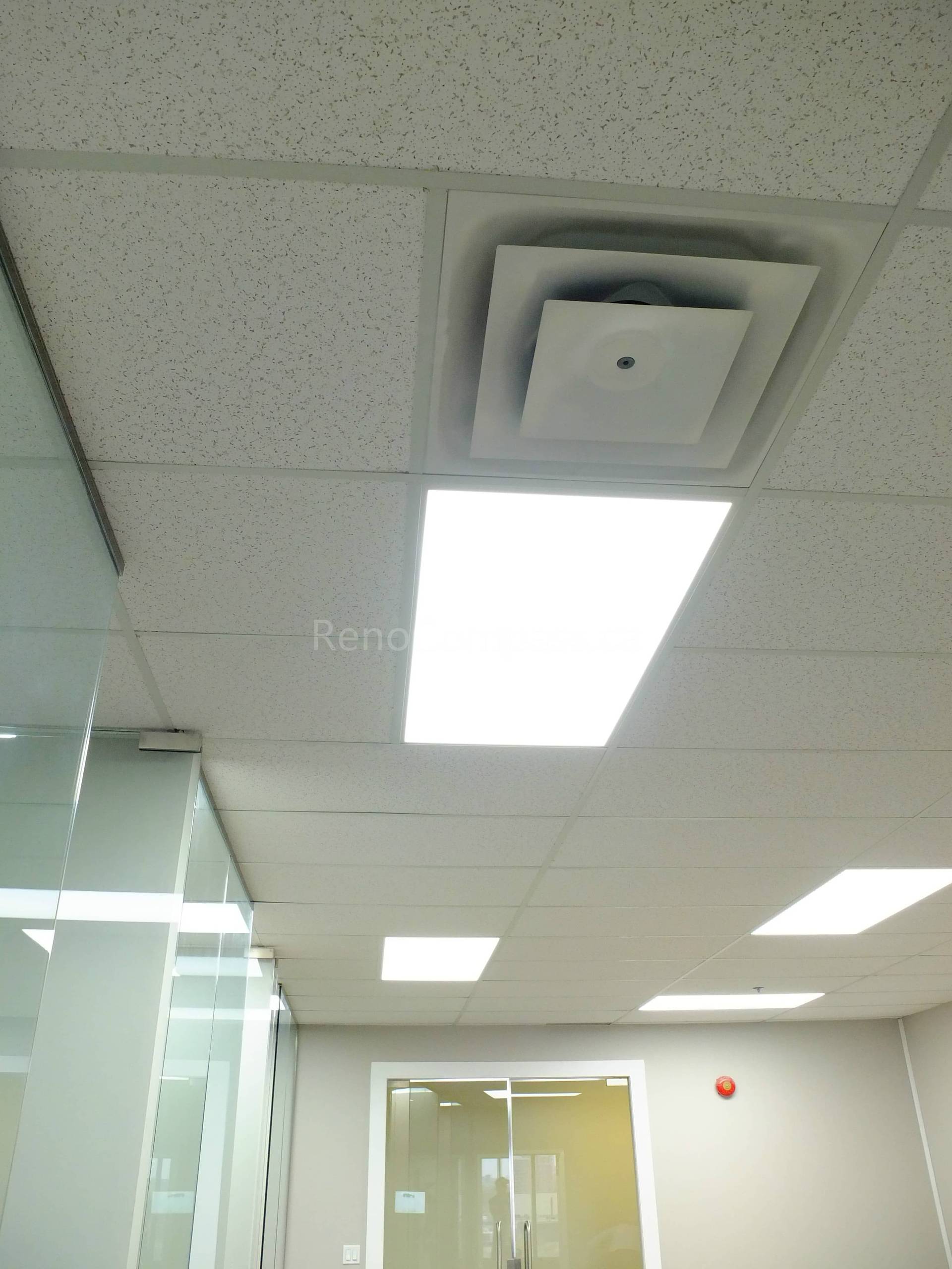 This photo shows a newly renovated office ceiling in North York, featuring modern suspended ceiling tiles and bright energy-efficient LED panel lights. The clean design enhances workspace illumination and creates a professional office environment.