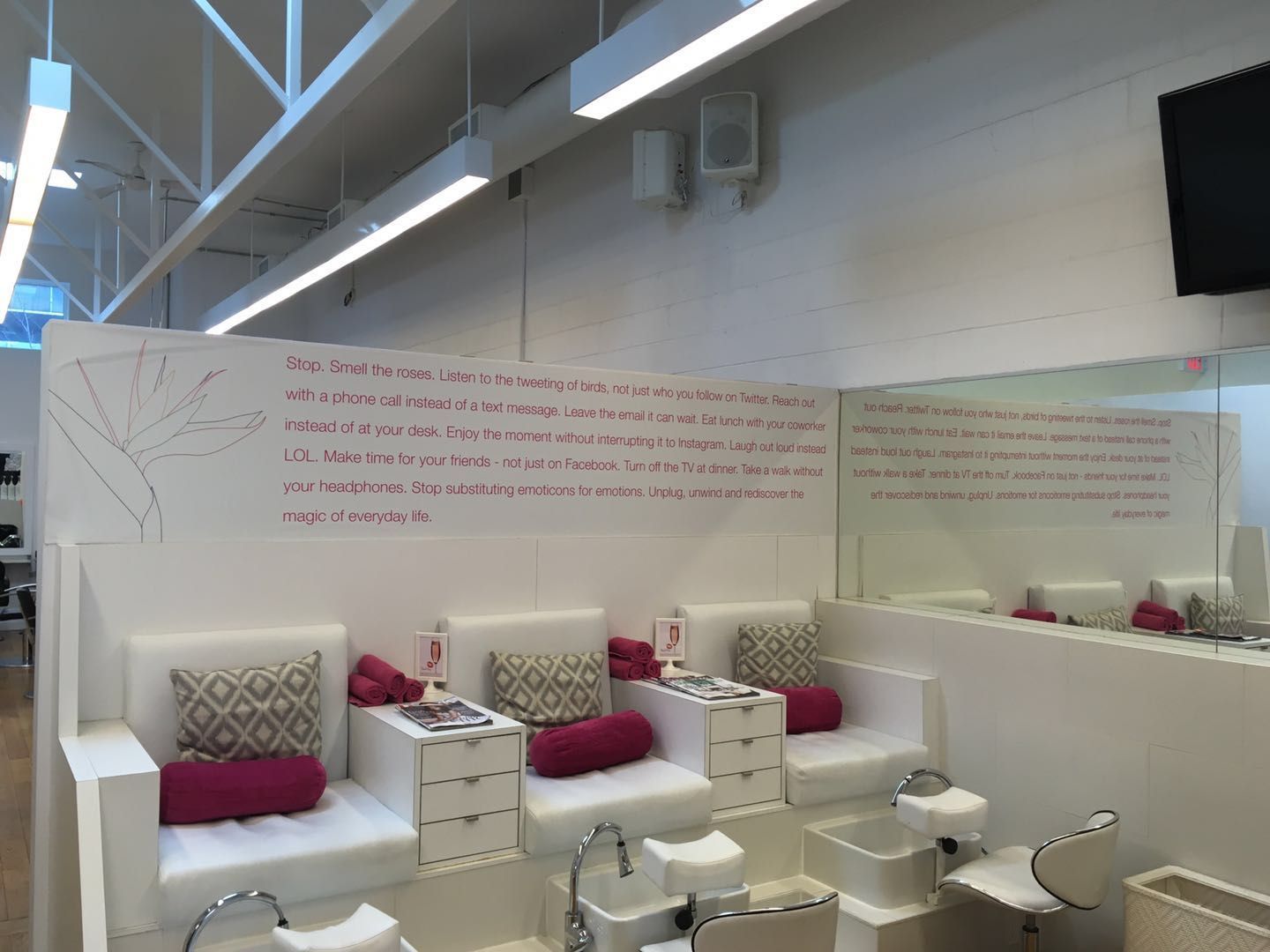 This Toronto spa renovation features a clean and inviting pedicure area with comfortable lounge seating, integrated foot spa stations, and a minimalist white interior design. The space is thoughtfully designed to enhance client relaxation while maintaining a professional and hygienic environment.