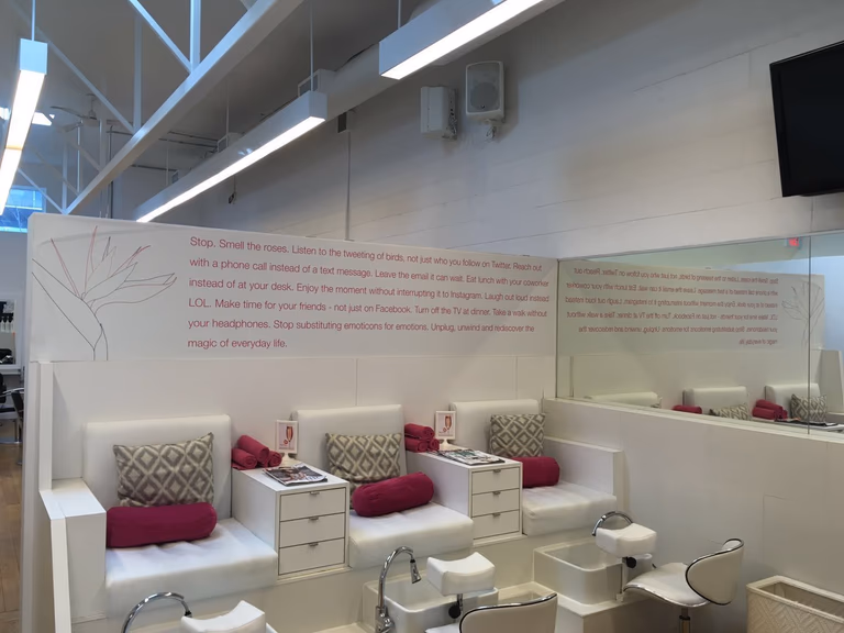 This Toronto spa renovation features a clean and inviting pedicure area with comfortable lounge seating, integrated foot spa stations, and a minimalist white interior design. The space is thoughtfully designed to enhance client relaxation while maintaining a professional and hygienic environment.
