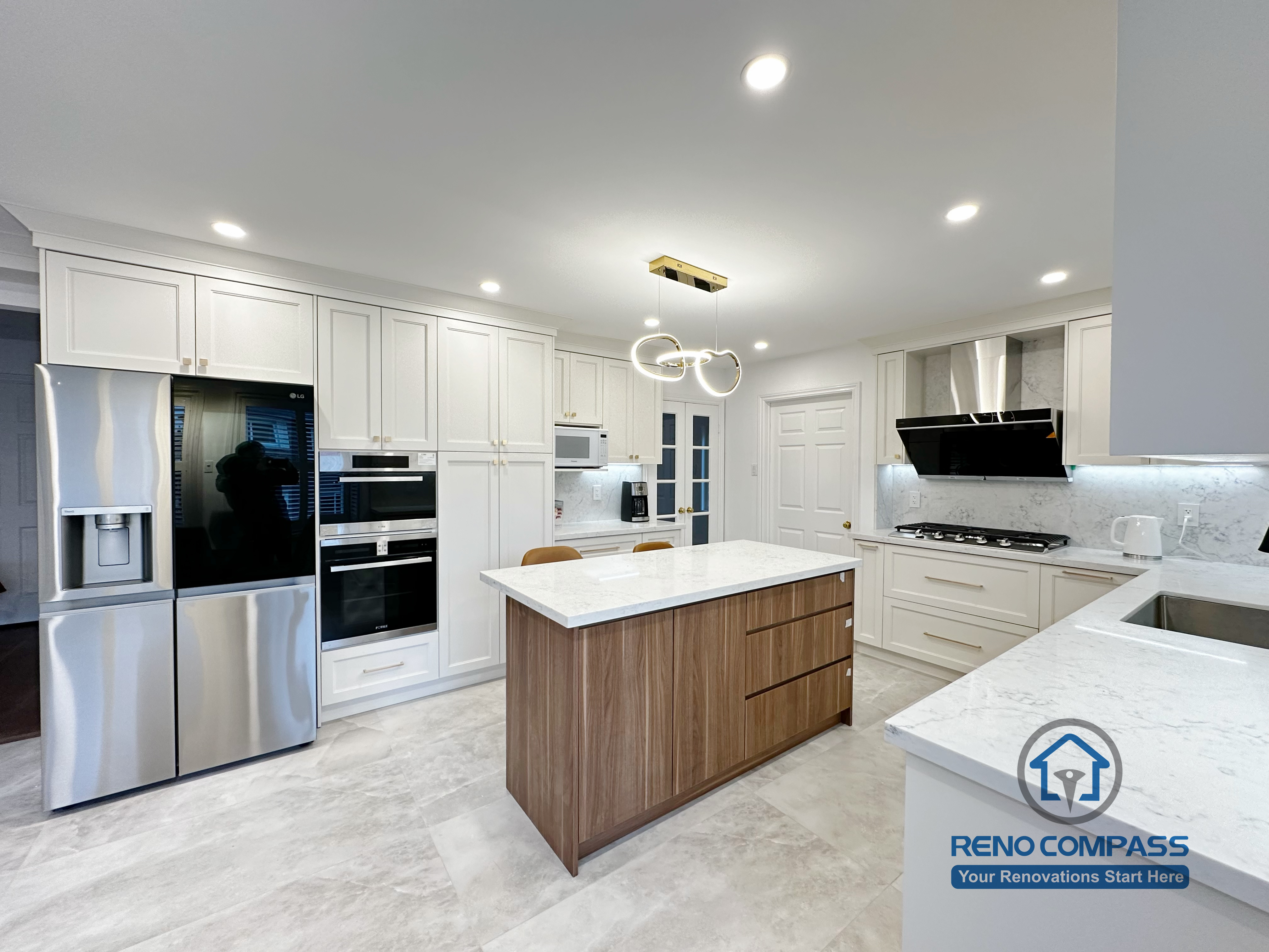 This Markham kitchen renovation showcases a spacious central island with quartz countertop, custom wood base cabinetry, and an open-concept layout that connects seamlessly to the living area. The design balances white perimeter cabinets with warm wood tones, improving both storage capacity and visual depth. Recessed lighting and modern pendant fixtures enhance overall brightness and functionality, making the kitchen ideal for daily cooking and entertaining.