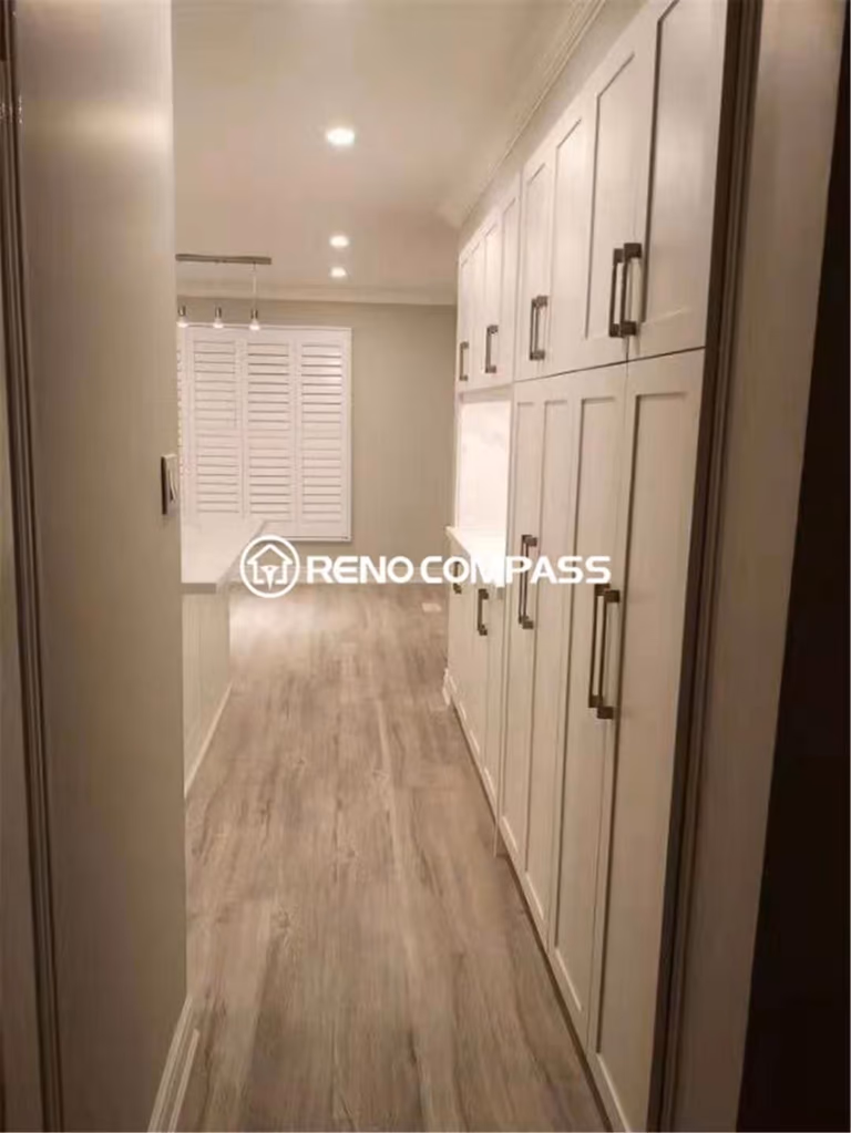 This Mississauga kitchen renovation showcases a custom-built storage and pantry cabinet wall designed to maximize organization and functionality. Completed by a trusted Toronto renovation company, the project features full-height shaker cabinets, modern hardware, upgraded flooring, and recessed lighting to create a clean and seamless transition between kitchen and dining areas. The redesigned layout improves daily usability while offering ample storage for a clutter-free space. Elegant finishes and durable materials ensure the kitchen remains both stylish and practical for long-term family living.