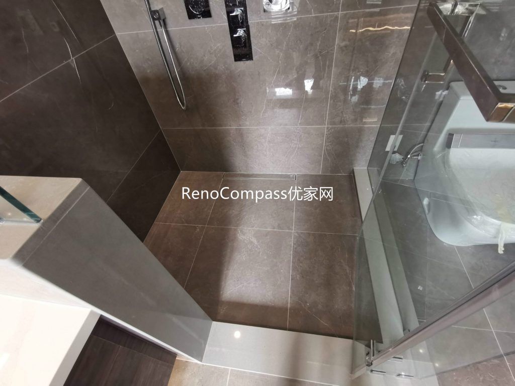 This Richmond Hill bathroom renovation features a modern walk-in shower with frameless glass enclosure, large-format tile finishes, and upgraded fixtures for a clean, spa-like experience. The functional layout and premium materials highlight the craftsmanship of a trusted Toronto renovation company specializing in full house interior and bathroom renovations.