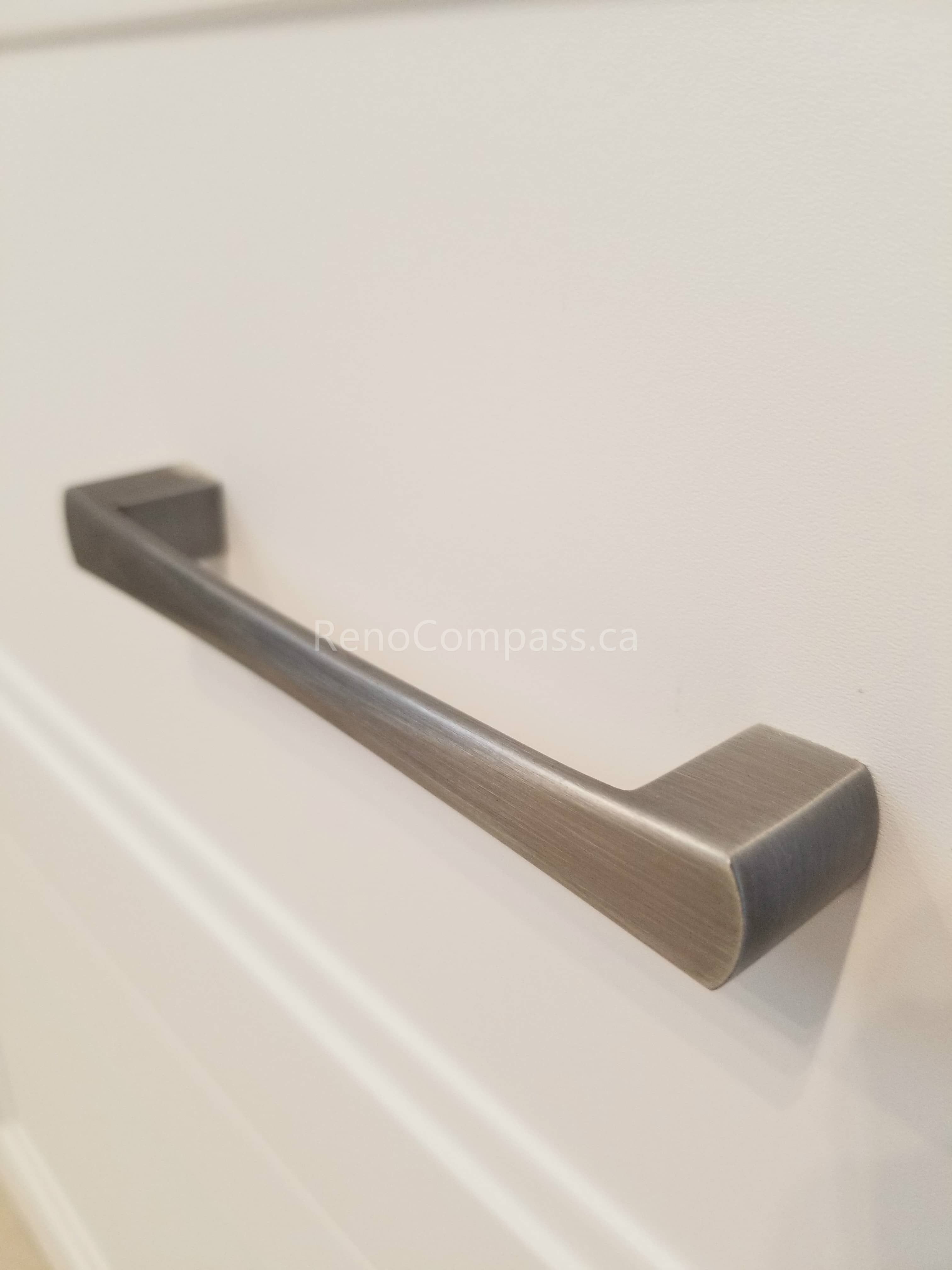 This Mississauga interior renovation detail highlights modern brushed nickel cabinet hardware installed on custom cabinetry. The sleek handle design adds a clean, contemporary touch while improving functionality and durability for everyday use.

Installed by Reno Compass Inc., this refined finishing detail enhances the overall quality and modern aesthetic of the renovated kitchen and bathroom spaces.