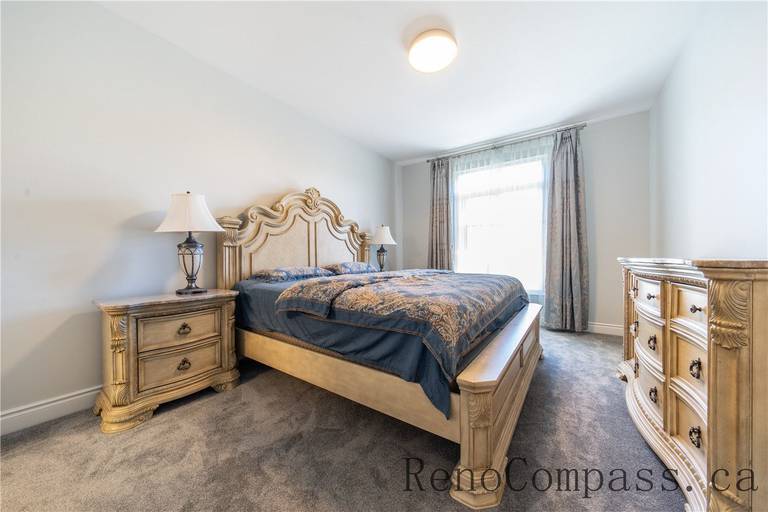 This Richmond Hill bedroom renovation features classic wall panel detailing, upgraded lighting, soft carpeting, and a refined layout that enhances comfort and elegance. The cohesive design and quality finishes create a warm, luxurious atmosphere, showcasing the craftsmanship of a trusted Toronto renovation company specializing in full house interior renovations.