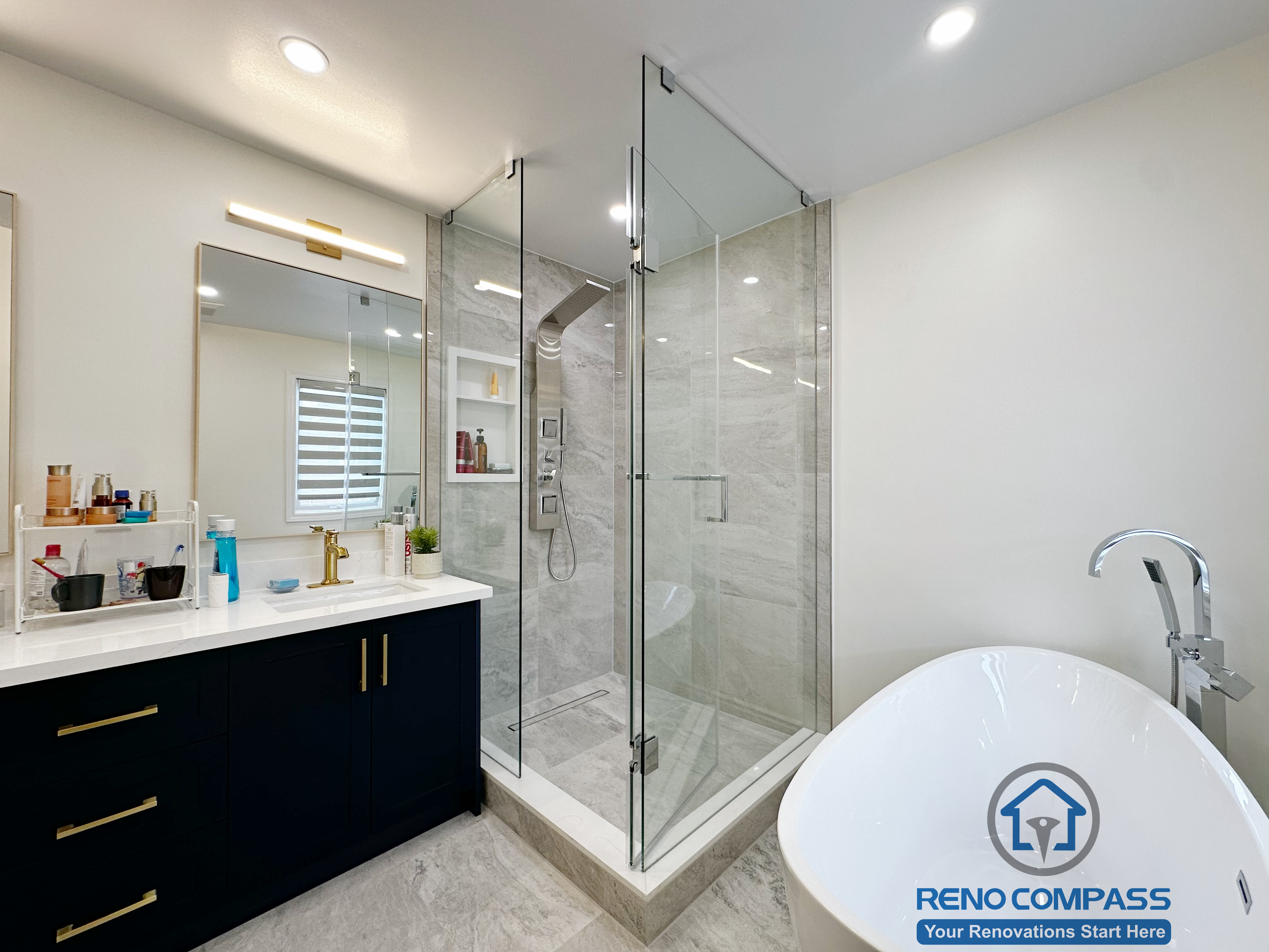 Master bathroom renovation in Markham featuring a frameless glass shower, large-format tile finishes, a custom vanity with matte black cabinetry, and brass fixtures. The design combines clean lines, efficient layout, and a refined modern aesthetic for everyday comfort.