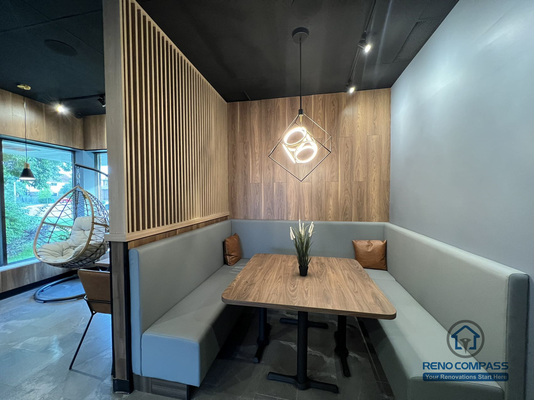 This Mississauga restaurant renovation features a semi-private booth seating area with custom millwork, wood panel accents, and integrated lighting. The layout creates a comfortable dining environment that enhances privacy while maintaining an open and modern restaurant interior.