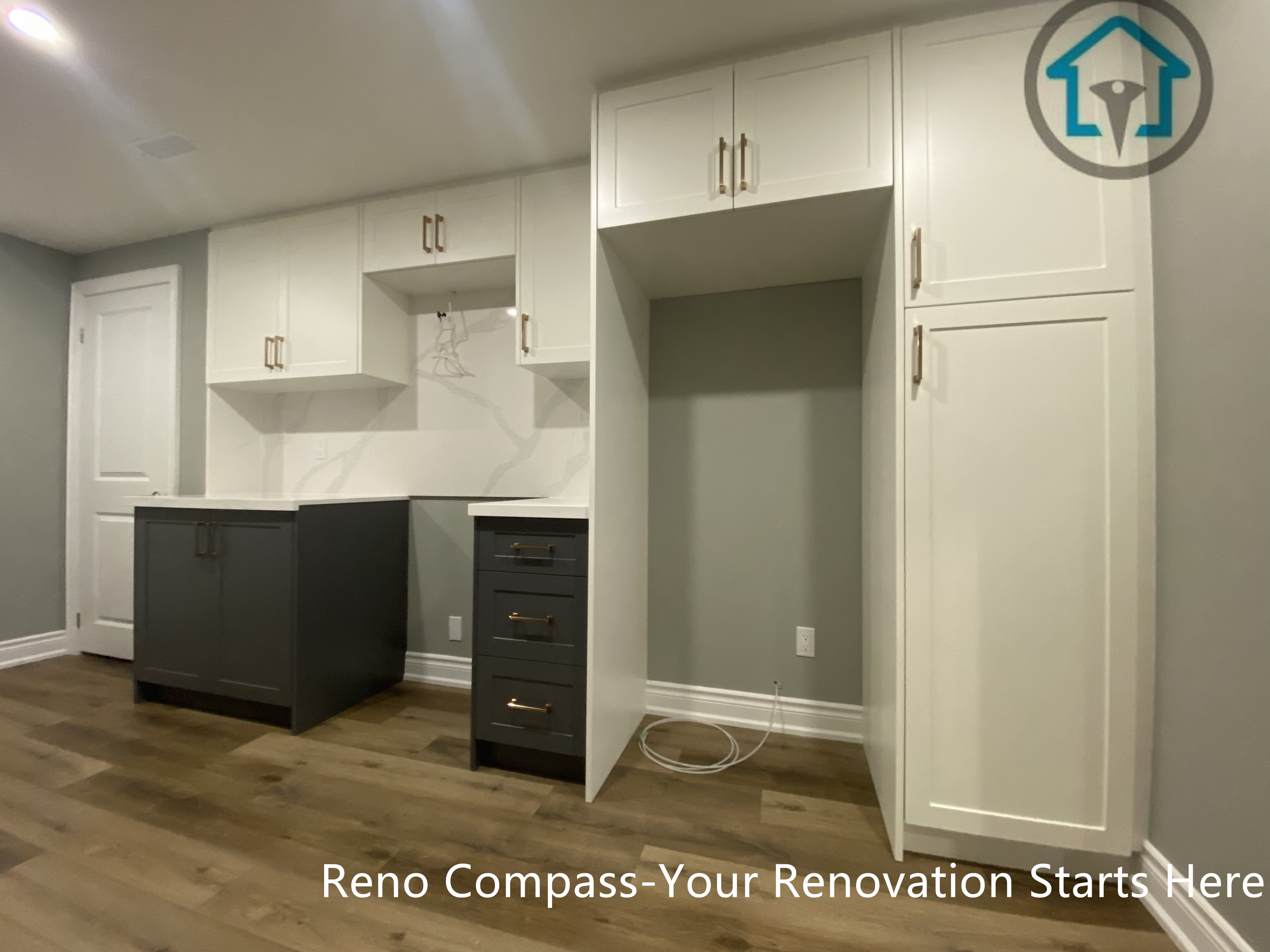 Custom-built basement cabinetry in Vaughan featuring full-height storage, integrated workspace, and durable wood-look flooring, designed to maximize organization and functionality within the basement renovation.