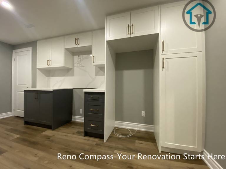 Custom-built basement cabinetry in Vaughan featuring full-height storage, integrated workspace, and durable wood-look flooring, designed to maximize organization and functionality within the basement renovation.