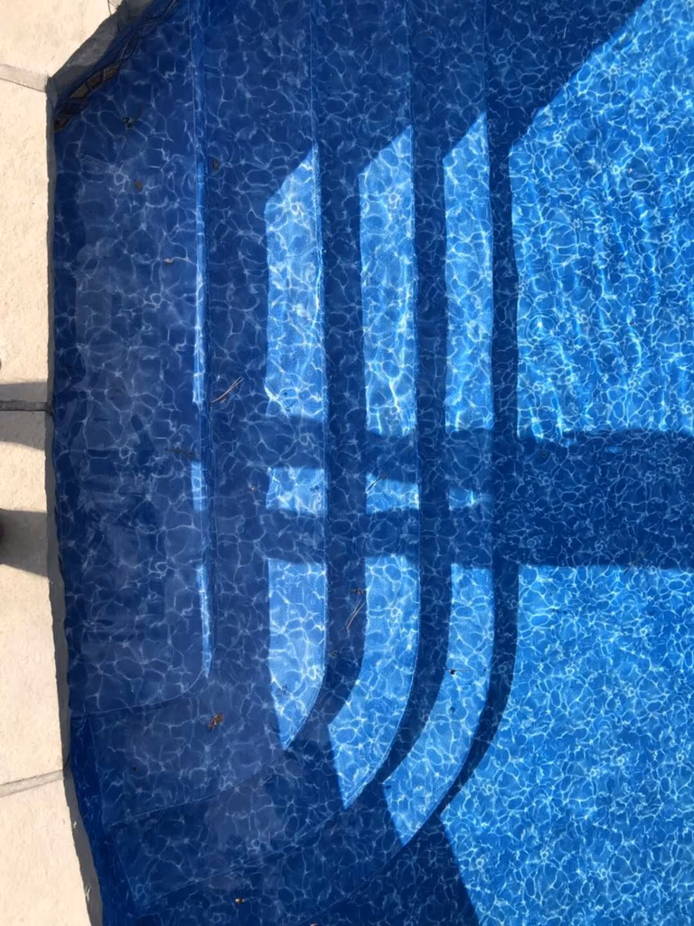 Beautifully renovated backyard swimming pool in Toronto. The new pool liner, resurfaced edges, and crystal-clear water showcase a complete transformation from old to new. Expert pool remodeling for modern outdoor living and relaxation.