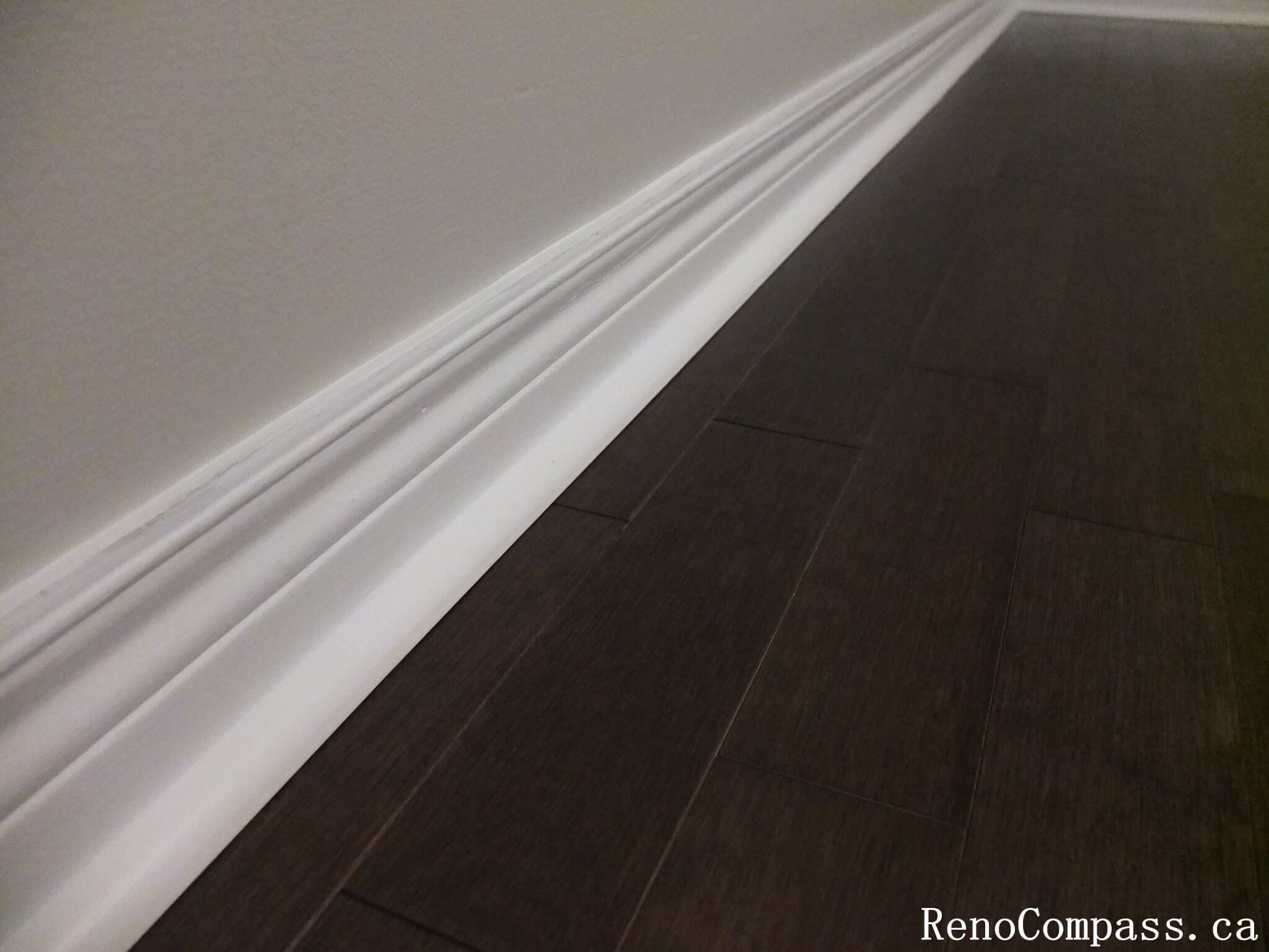 This Richmond Hill interior renovation highlights precise baseboard trim installation paired with rich hardwood flooring for a clean and polished finish. Completed by an experienced Toronto renovation company, the detailed craftsmanship enhances durability, visual continuity, and overall interior quality. The combination of modern flooring and refined trim work creates a cohesive and elegant living environment throughout the home.