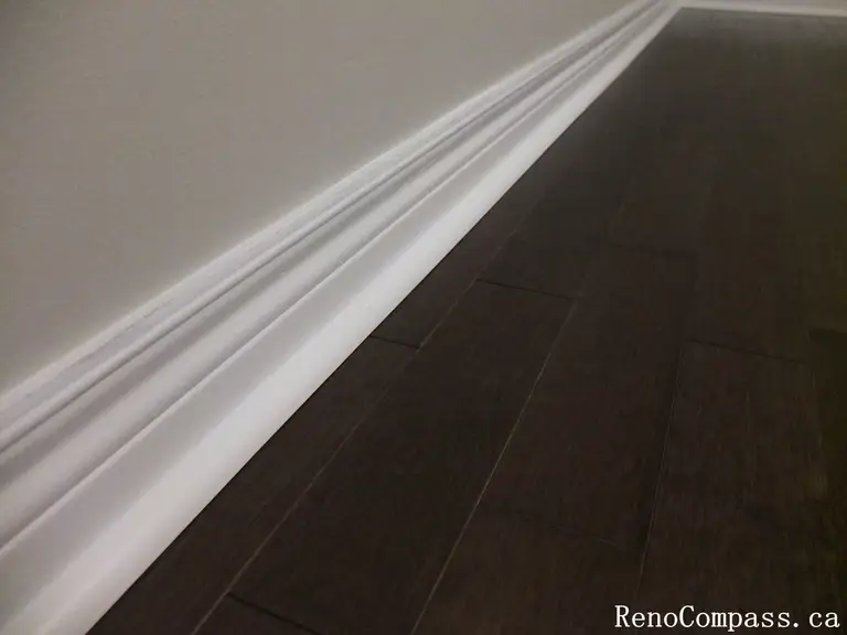 This Richmond Hill interior renovation highlights precise baseboard trim installation paired with rich hardwood flooring for a clean and polished finish. Completed by an experienced Toronto renovation company, the detailed craftsmanship enhances durability, visual continuity, and overall interior quality. The combination of modern flooring and refined trim work creates a cohesive and elegant living environment throughout the home.