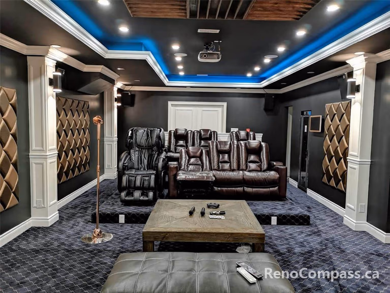 High-end home theatre installation in Mississauga featuring a large projection screen, custom ceiling lighting, built-in speakers, and luxury reclining seating. This professionally designed basement cinema combines acoustic optimization, modern lighting design, and premium finishes to create an immersive private movie theatre experience for homeowners seeking comfort and entertainment.