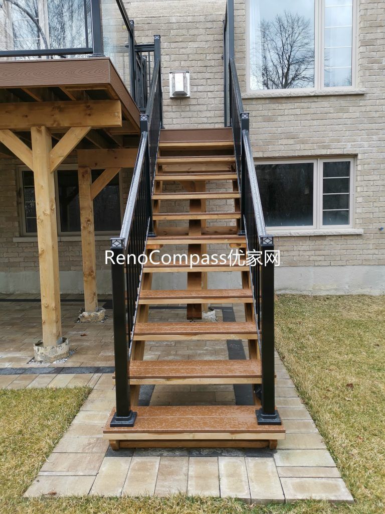Custom backyard renovation in Aurora featuring solid wood deck stairs, modern railing installation, and professionally installed interlocking patio flooring. This outdoor upgrade enhances accessibility, durability, and overall backyard functionality while creating a clean and stylish landscape design.