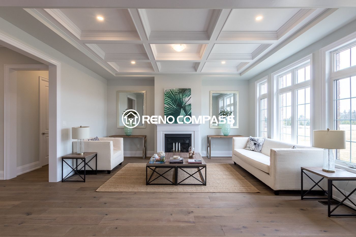 This image shows a Newmarket living room renovation featuring professionally installed engineered wood flooring. The natural wood flooring enhances the modern interior design while providing durability and stability. The project was completed by Reno Compass Inc., a Toronto renovation company specializing in flooring and interior renovations.