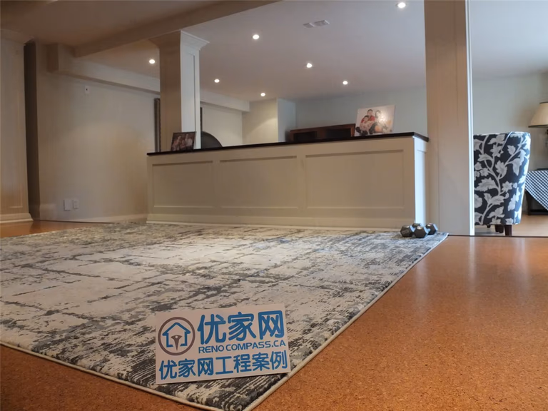 This Oakville basement renovation showcases an open-concept living space featuring engineered flooring, custom half-wall paneling, and recessed pot lighting. The layout creates a spacious and inviting environment suitable for family gatherings and relaxation. Completed by a professional Toronto Renovation Company, the project highlights clean craftsmanship, balanced lighting, and a modern basement design tailored for comfortable everyday living.