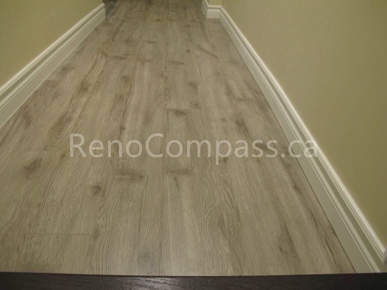 New waterproof vinyl flooring installed in this Markham basement renovation project, featuring durable wood-look planks and clean modern baseboards. Completed by Reno Compass, this basement upgrade enhances comfort, moisture resistance, and contemporary interior style for a functional finished living space.