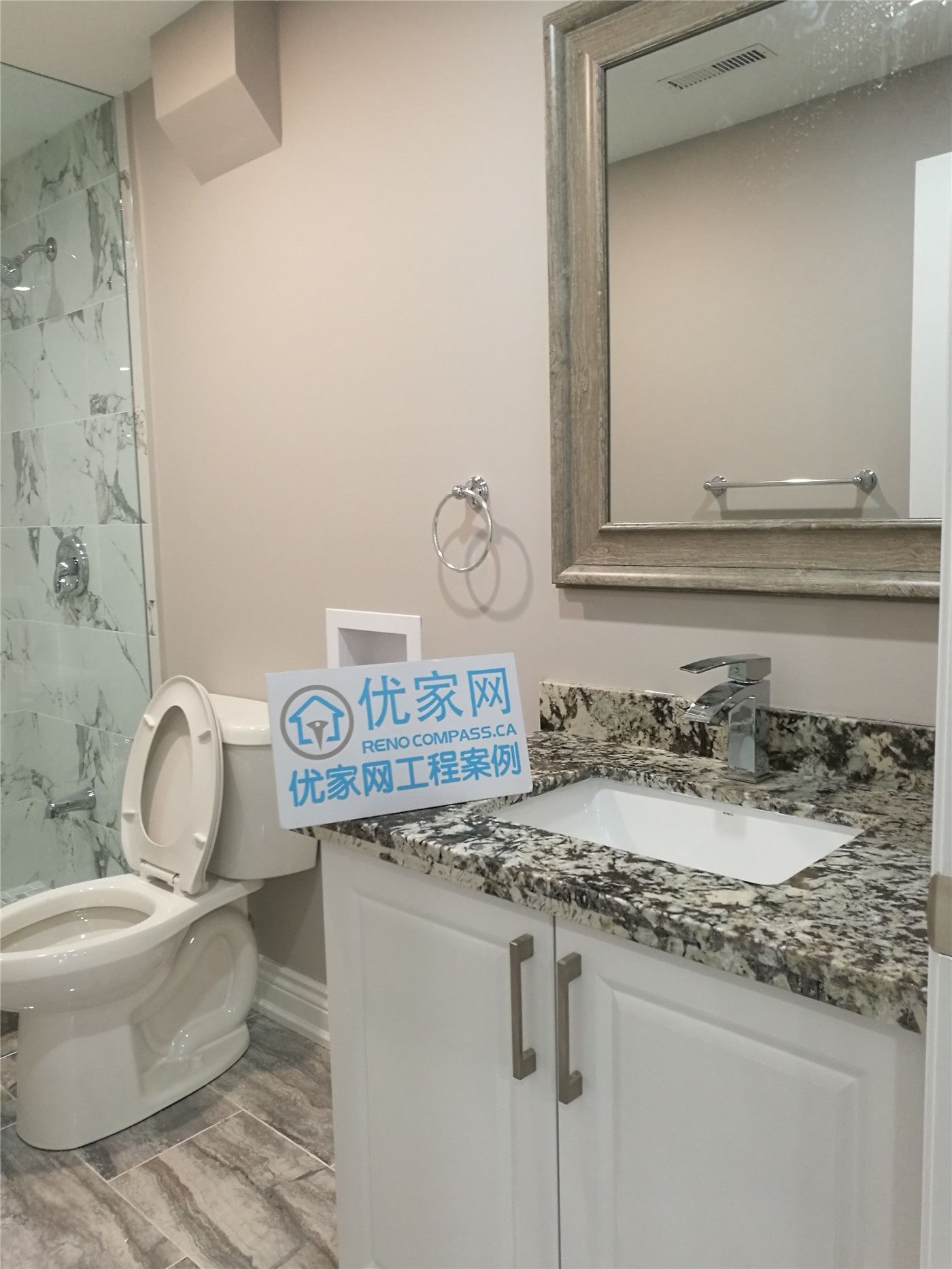 Basement bathroom renovation in Richmond Hill showcasing a custom vanity with granite countertop, modern sink and faucet, updated toilet installation, and neutral wall finishes. This basement bathroom remodel enhances storage, functionality, and overall comfort, completed by a professional Toronto renovation company.
