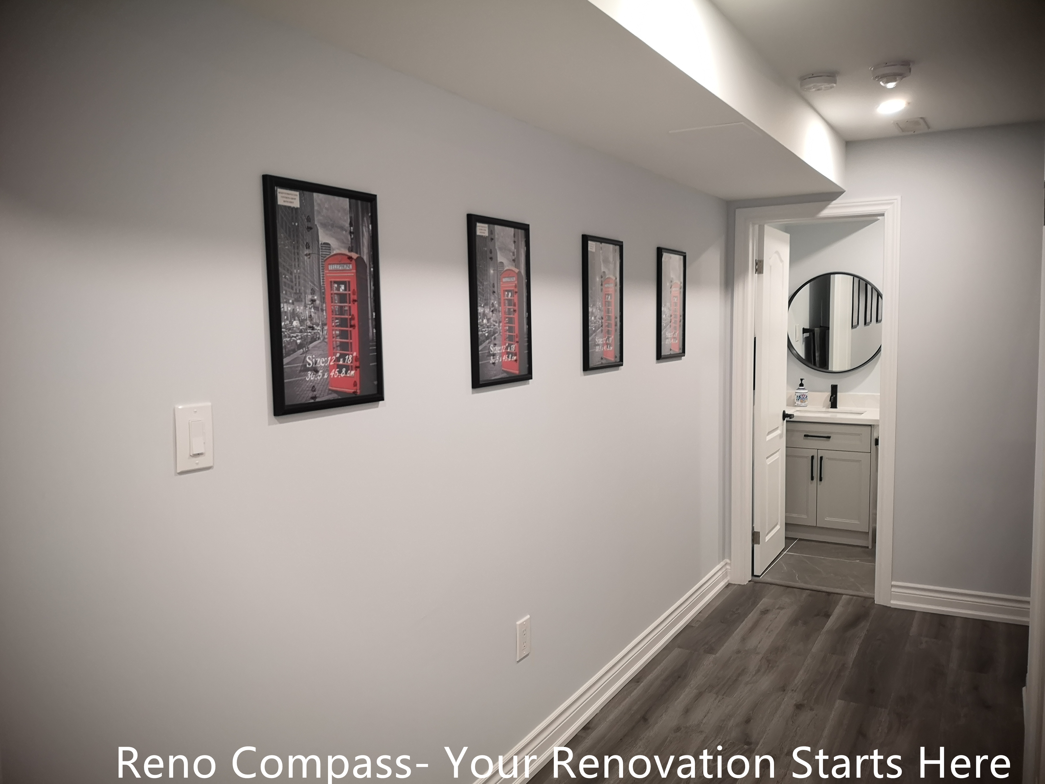 This Whitby basement renovation features a clean and well-lit hallway that connects the main basement area to the bathroom. Continuous wood-look flooring enhances visual flow, while recessed ceiling lights provide balanced illumination throughout the corridor. Minimal wall finishes and framed artwork add subtle character without overwhelming the space. The layout improves circulation and accessibility, reinforcing the functionality and comfort of the finished basement design.