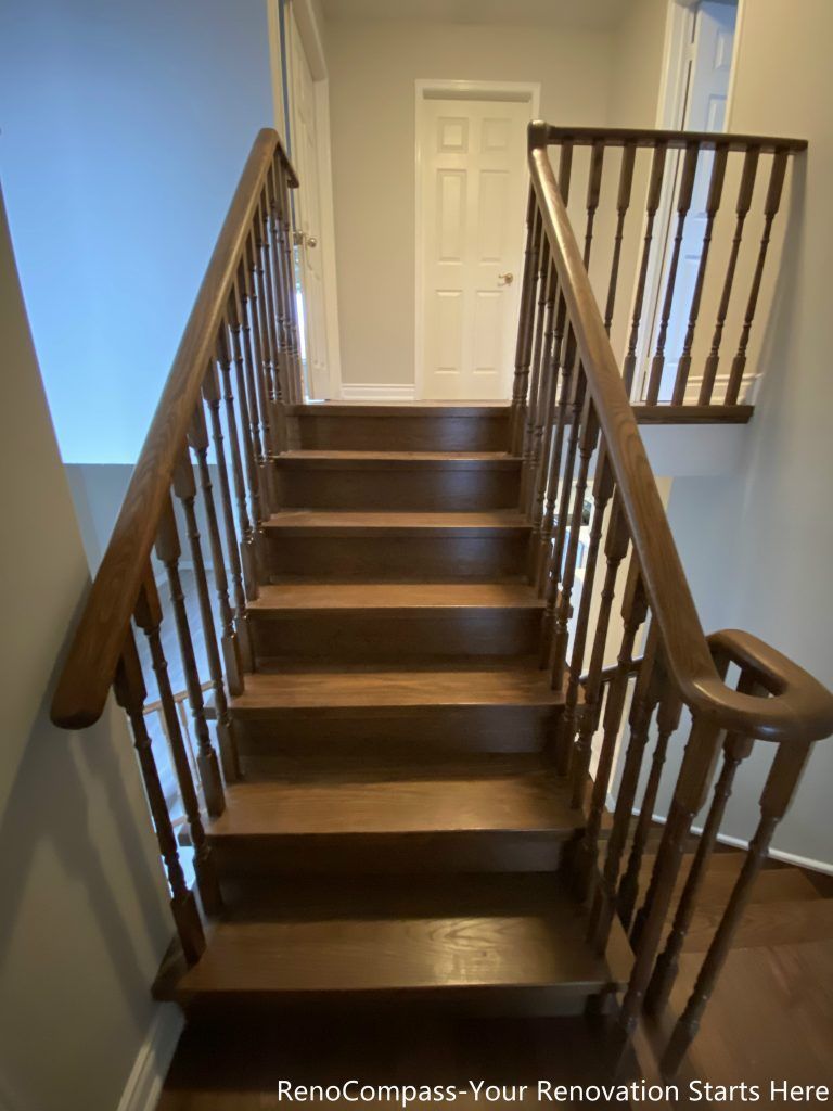 This Mississauga interior renovation features a refinished hardwood staircase with solid wood treads, matching handrails, and classic wooden balusters. The warm wood tones add continuity to the surrounding hardwood flooring, while the clean stair layout improves safety, durability, and visual flow between levels. This staircase renovation enhances both functionality and overall interior cohesion, making it a lasting upgrade for everyday family use.