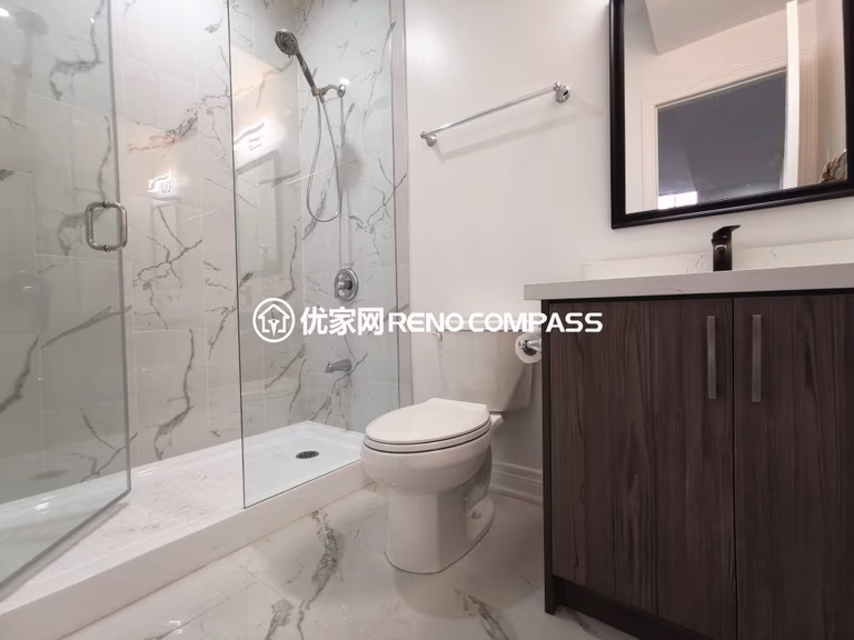 This Vaughan basement bathroom renovation features a modern glass shower enclosure with marble-style wall tiles, upgraded vanity, and contemporary fixtures. The clean layout and durable finishes create a bright, functional, and stylish bathroom designed for everyday comfort. Completed by a professional Toronto renovation company, this basement bathroom upgrade enhances both practicality and home value with quality craftsmanship and modern design.