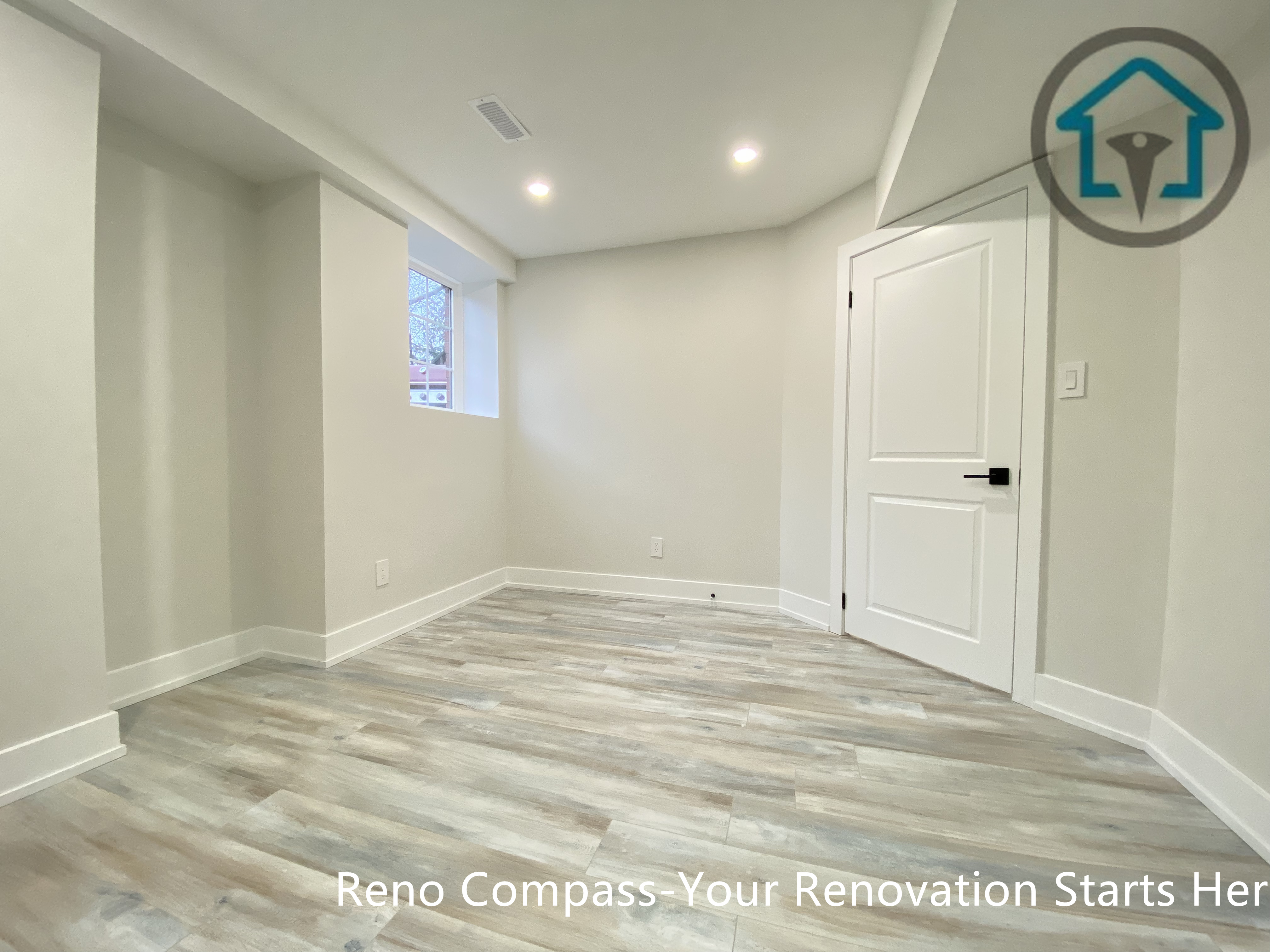 This Stouffville basement renovation showcases newly installed vinyl plank flooring, smooth drywall finishes, and modern interior doors with black hardware. The clean layout and neutral color palette create a bright, functional basement space suitable for bedroom, office, or family room use, completed by Reno Compass Inc.