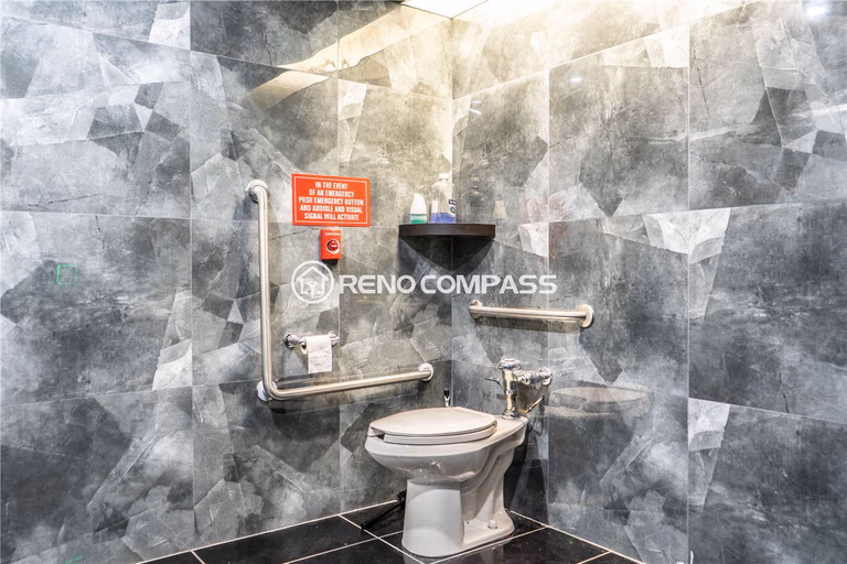 Commercial washroom renovation for a Markham internet cafe featuring modern tile wall finishes, accessibility grab bars, durable flooring, and efficient layout design. This commercial renovation project highlights professional plumbing installation, safety compliance upgrades, and contemporary interior finishing, creating a clean and functional restroom space by experienced Toronto renovation contractor Reno Compass Inc.