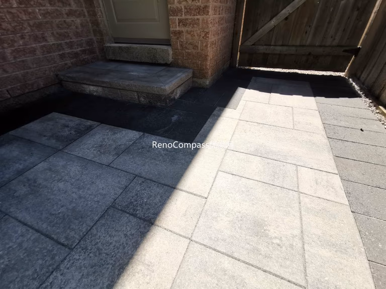 Front entrance interlocking and walkway paving completed in Mississauga featuring large-format patio stones and contrasting border design. This professionally installed stonework enhances curb appeal, improves drainage, and provides a durable, low-maintenance outdoor surface for everyday use.