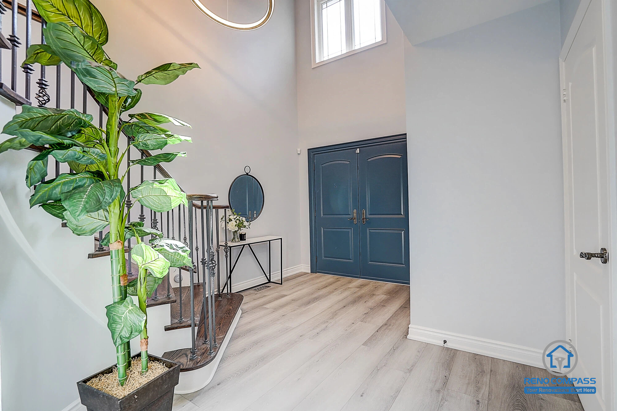 Upgraded staircase in Vaughan home renovation with dark wood steps and modern railing, enhancing the overall interior design and first impression.