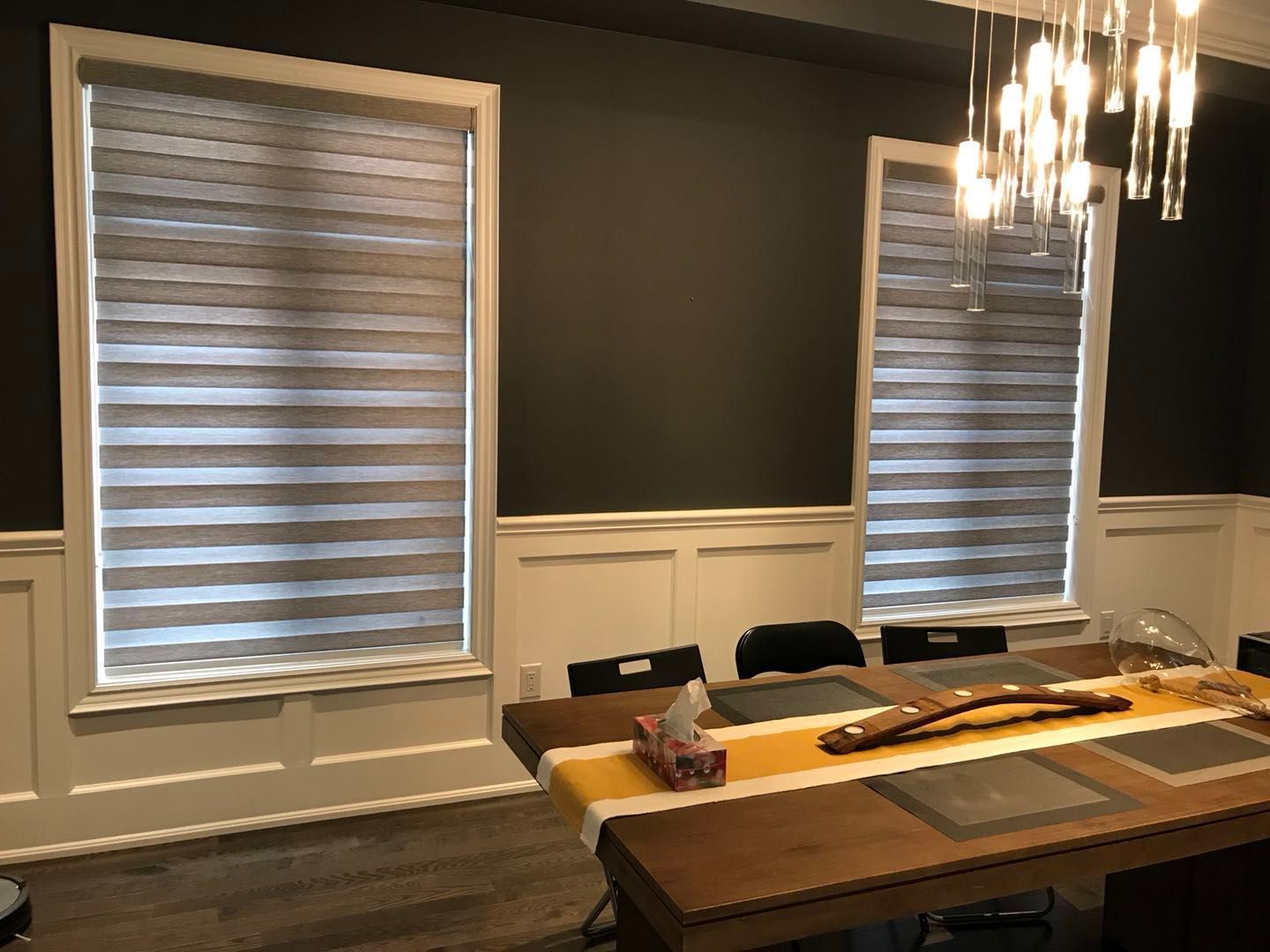 Custom zebra blinds installation in Toronto dining room by professional Toronto renovation company Reno Compass Inc. Featuring dual-layer light filtering shades, clean white window trim, modern chandelier lighting, and elegant wall panel detailing. This window treatment upgrade enhances privacy, natural light control, and interior aesthetics with a sleek and contemporary finish.