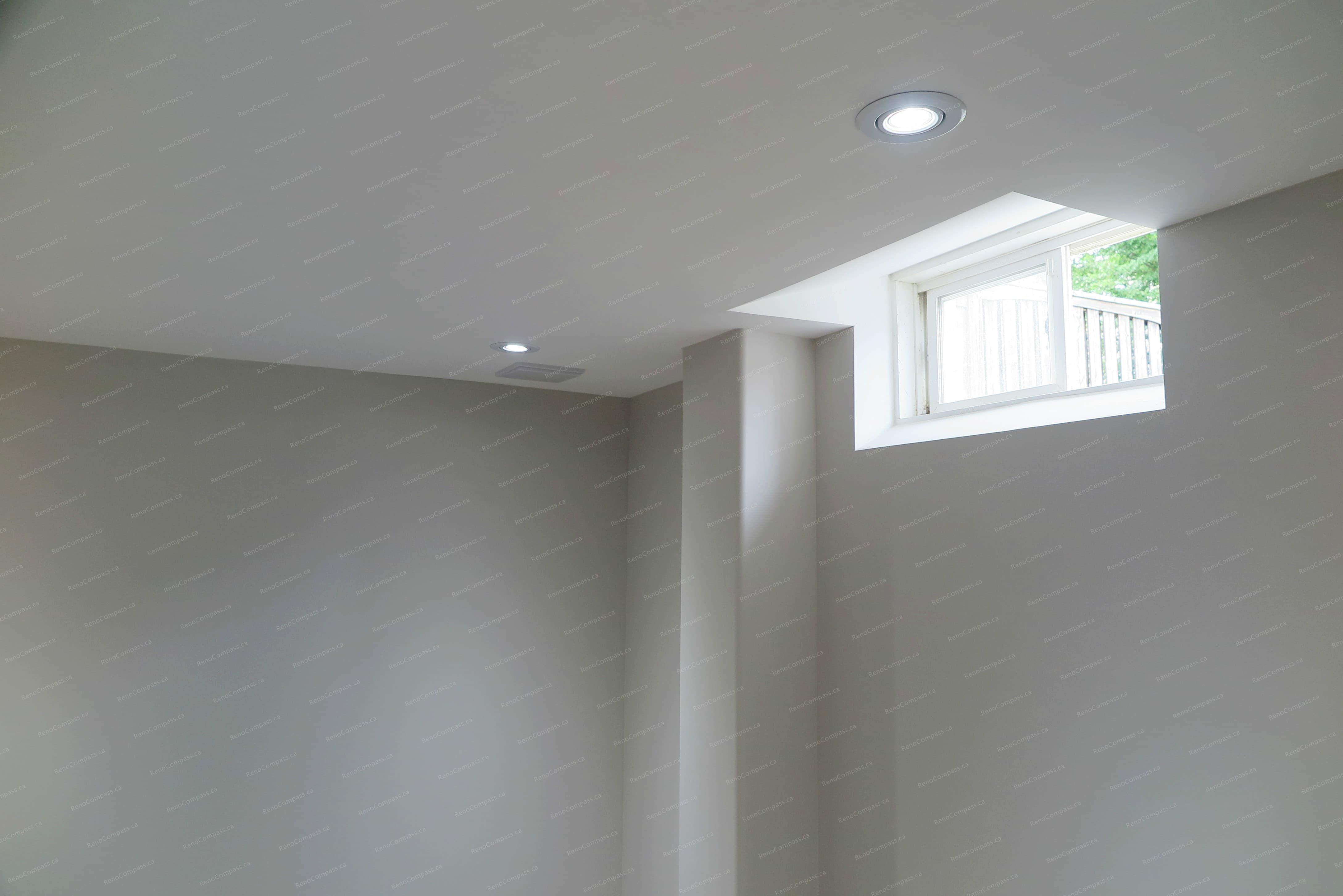 This Richmond Hill basement renovation features recessed ceiling lighting and a high-set window that enhances natural light, improving brightness and overall comfort in the space.