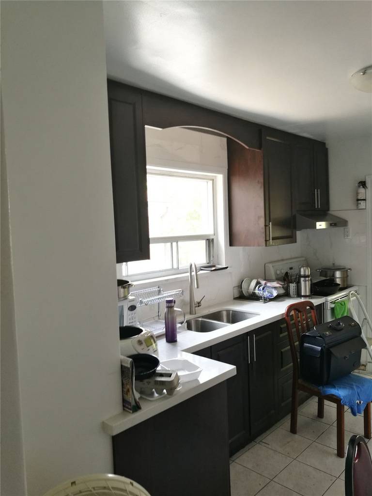 Completed kitchen renovation in Richmond Hill showcasing sleek cabinetry, marble-inspired backsplash, and elegant lighting, crafted by Toronto renovation company Reno Compass Inc.