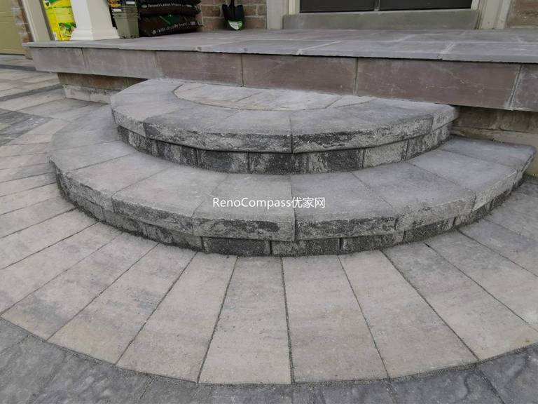 Custom curved interlocking stone steps designed for a Vaughan home’s front entrance. Built with precision and seamless color coordination to match the driveway, this Reno Compass project enhances both function and visual appeal.