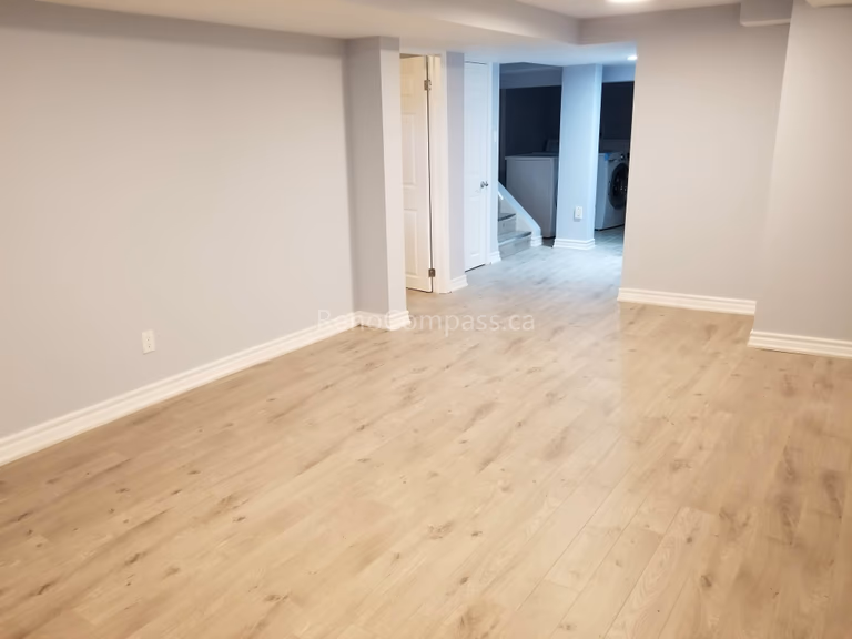This Mississauga basement renovation features a clean, modern open-concept layout with newly installed light-tone flooring and fresh neutral wall finishes. The upgraded space offers improved brightness, comfort, and functionality, creating a versatile area suitable for family living, entertainment, or rental potential.

Completed by Reno Compass Inc., this basement upgrade highlights quality flooring installation, refined finishing details, and professional craftsmanship to enhance both usability and property value.