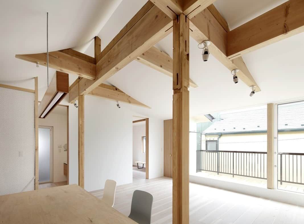 This Toronto modern luxury interior showcases a bright open-concept layout with natural wood beam structures, high ceilings, and large windows that bring in abundant natural light. The minimalist design blends contemporary aesthetics with warm wooden elements, creating a spacious and elegant living environment. Designed and built by a professional Toronto renovation company, this project highlights clean architectural lines, premium materials, and functional modern living.