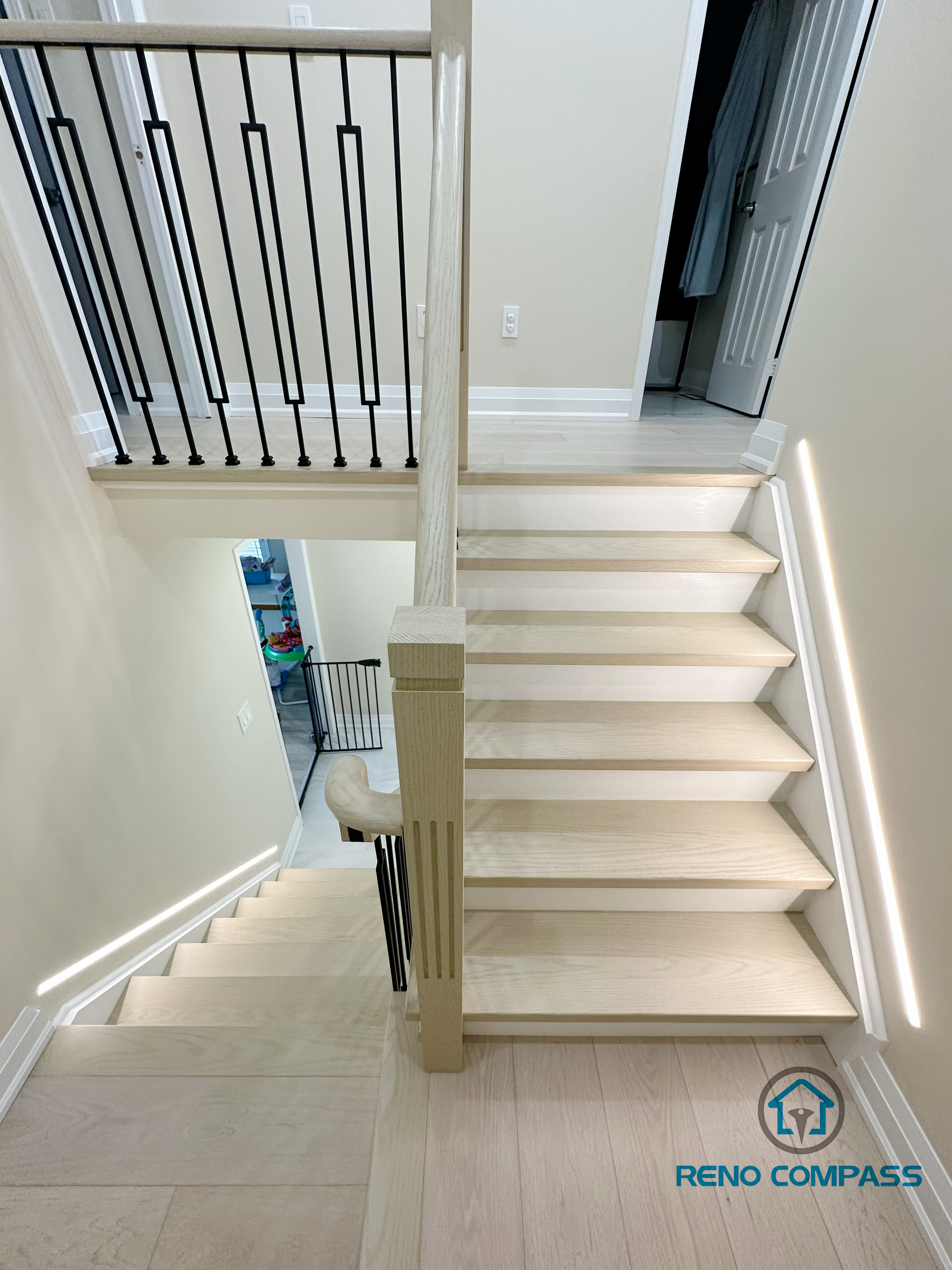 A stunning modern staircase renovation in Vaughan featuring custom floating wooden steps, sleek glass railings, and integrated LED lighting for a contemporary and open feel.