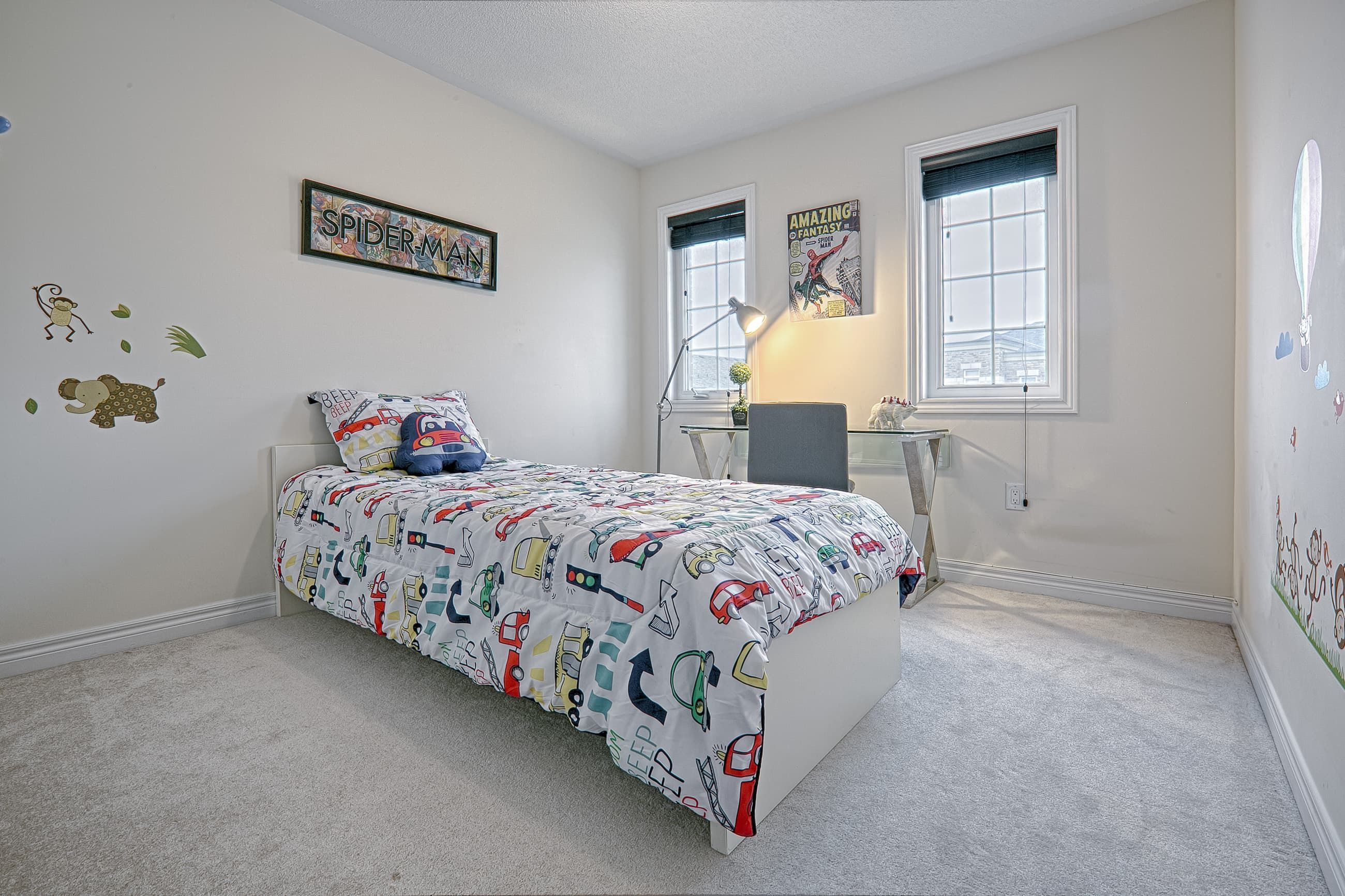 This bright and functional kids’ bedroom renovation features soft neutral walls, plush carpeting, and large windows that allow natural light to enhance the space. The layout includes a cozy bed setup with playful décor and a compact study desk positioned by the window to maximize productivity and comfort. Designed to balance practicality and style, this bedroom upgrade reflects the quality craftsmanship of a professional Toronto renovation company specializing in modern residential interior transformations.