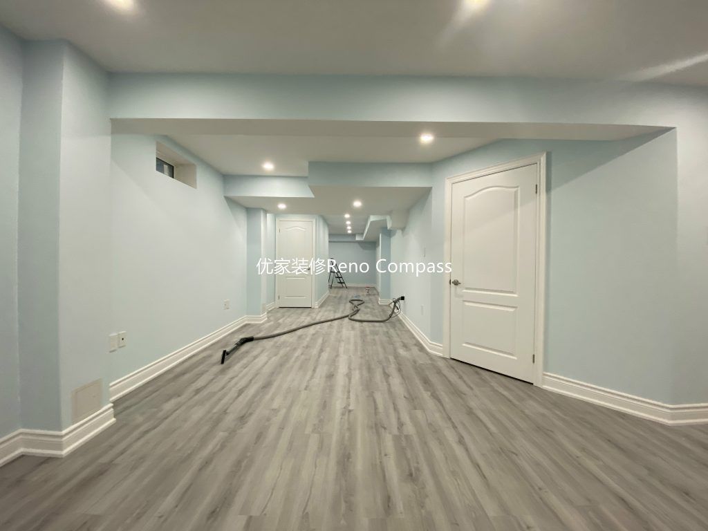 This Aurora basement renovation project showcases a fully upgraded lower-level living space completed by a professional Toronto renovation company. The basement features newly installed durable vinyl flooring, smooth finished walls, modern white trim, and evenly distributed LED pot lights to create a bright and comfortable environment. Clean lines, neutral tones, and an open layout transform the basement into a functional multi-purpose living area ideal for family use, rental potential, or entertainment space. Contractor: Reno Compass Inc.