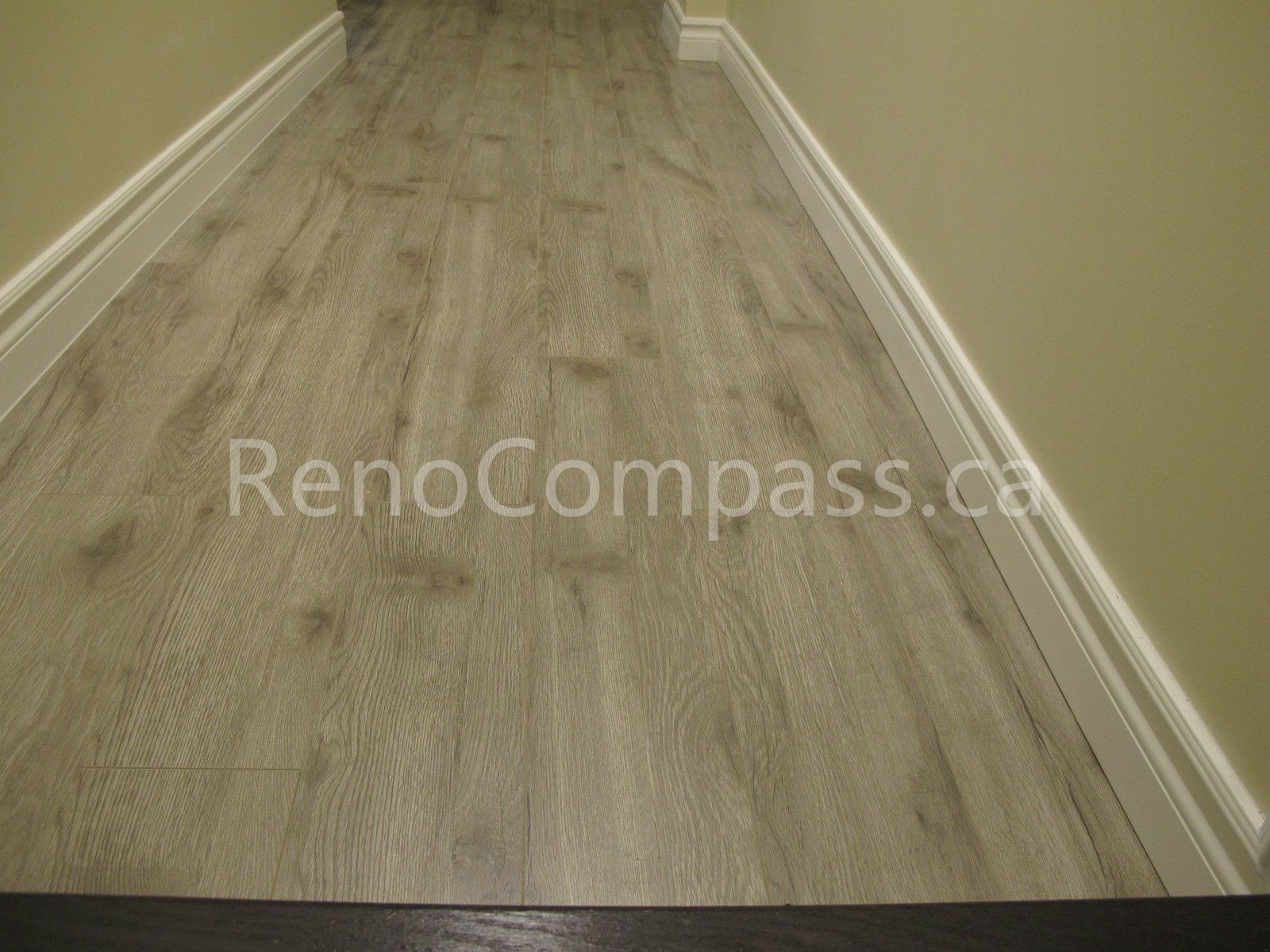 New waterproof vinyl flooring installed in this Markham basement renovation project, featuring durable wood-look planks and clean modern baseboards. Completed by Reno Compass, this basement upgrade enhances comfort, moisture resistance, and contemporary interior style for a functional finished living space.
