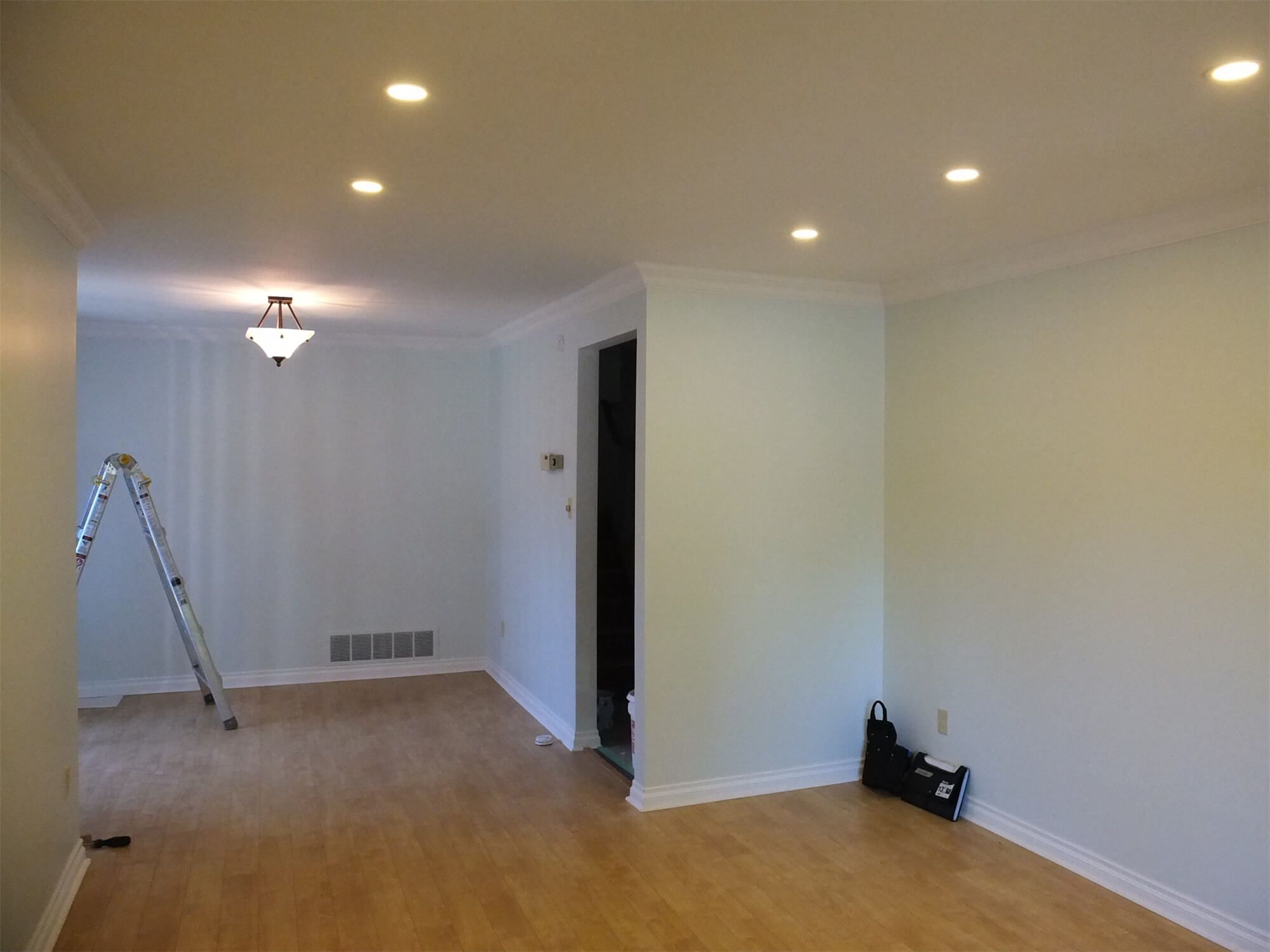 This Oshawa interior renovation project showcases a bright and refreshed open-concept living and dining area. The space features newly refinished hardwood flooring, smooth ceiling with recessed pot lights, upgraded crown molding, and a clean neutral wall palette to enhance natural light. The updated lighting layout improves functionality while creating a warm and inviting atmosphere. Completed with precision and attention to detail, this project reflects the professional craftsmanship of a trusted Toronto Renovation Company, delivering a modern and cohesive interior transformation.
