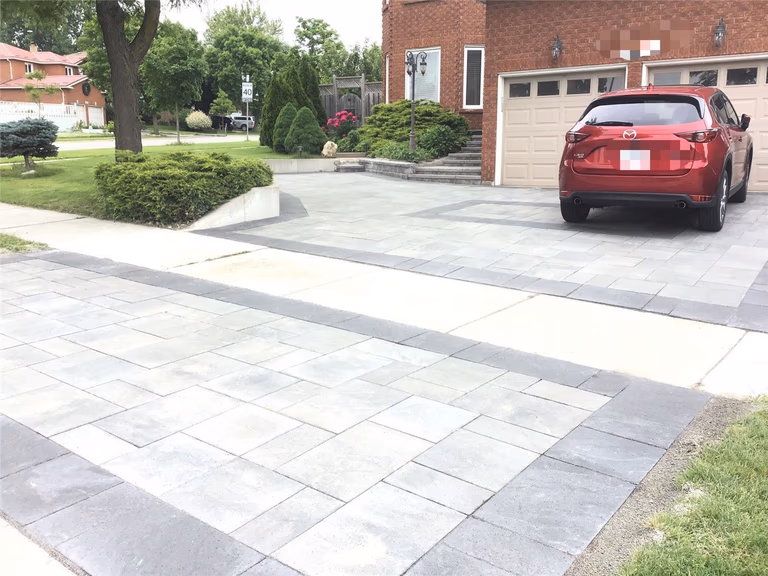 A complete front yard landscaping renovation in Mississauga featuring a modern interlocking driveway, clean border detailing, and a spacious parking layout. This project enhances curb appeal, improves functionality, and delivers a durable, low-maintenance outdoor surface designed for long-term use.