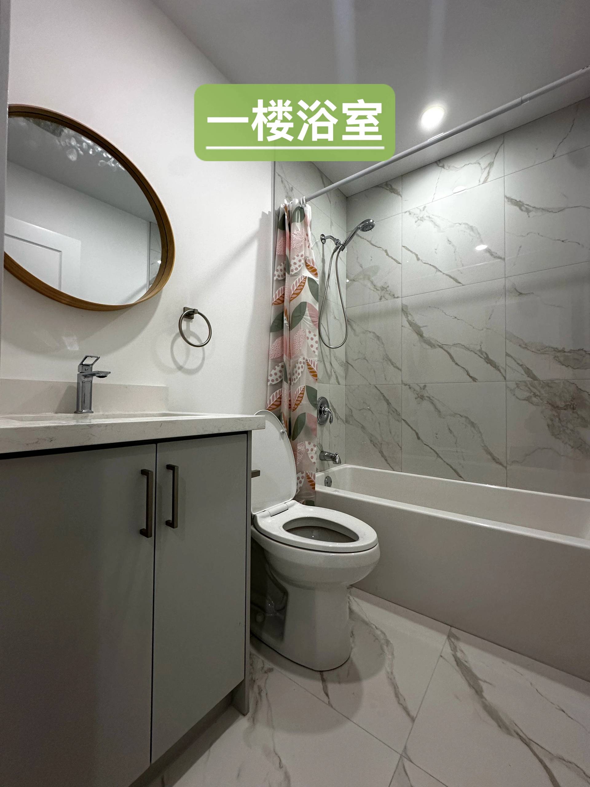 This main floor bathroom features a modern design with full bathtub, vanity, and upgraded finishes. As part of a Toronto legal 3-unit conversion, the space supports independent living and enhances rental appeal.