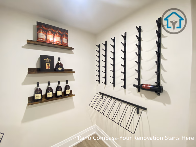 This image features a custom-designed wine cellar within a Richmond Hill interior renovation, showcasing symmetrical wall-mounted wine racks and a clean, gallery-style layout. The narrow corridor design maximizes bottle storage while maintaining visual order and ease of access. Neutral finishes and wood flooring add warmth and balance to the space. Designed and completed by Reno Compass, this wine storage solution reflects a refined approach to functional interior design for homes in Richmond Hill.