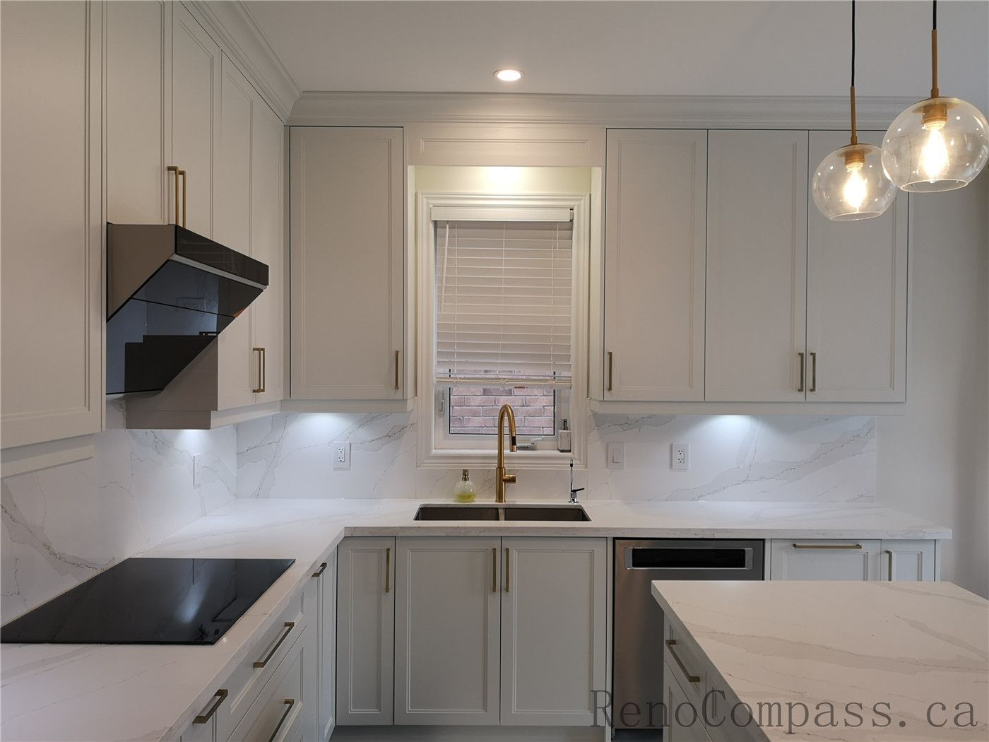 This Aurora kitchen renovation showcases a modern and elegant layout with custom white shaker cabinets, quartz countertops, marble-style backsplash, and stylish brushed gold hardware. Under-cabinet lighting enhances both functionality and ambiance, while the centered window sink design creates a bright and balanced workspace. Completed by a professional Toronto renovation company focused on quality craftsmanship, timeless design, and practical everyday living.