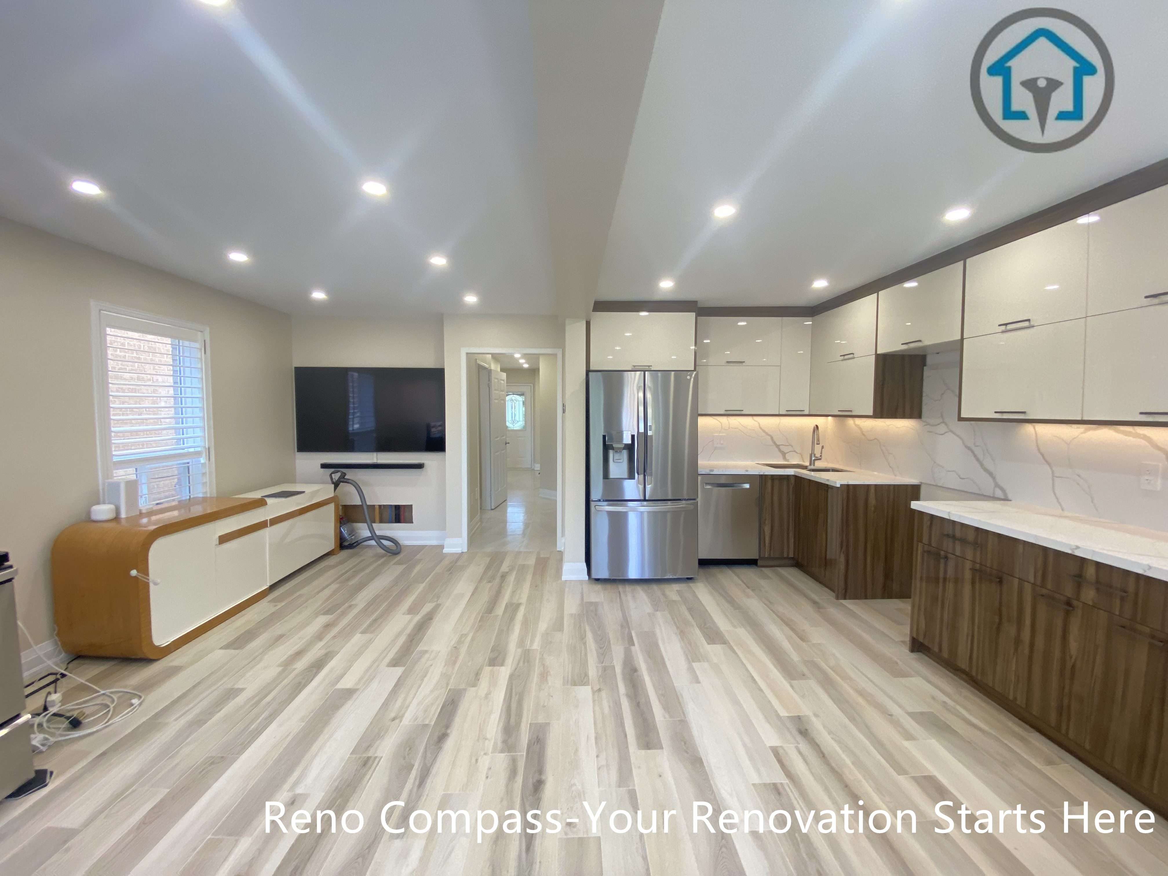 Open concept kitchen and living area from a completed interior renovation project in Vaughan, featuring a bright layout and seamless connection between spaces by Reno Compass.