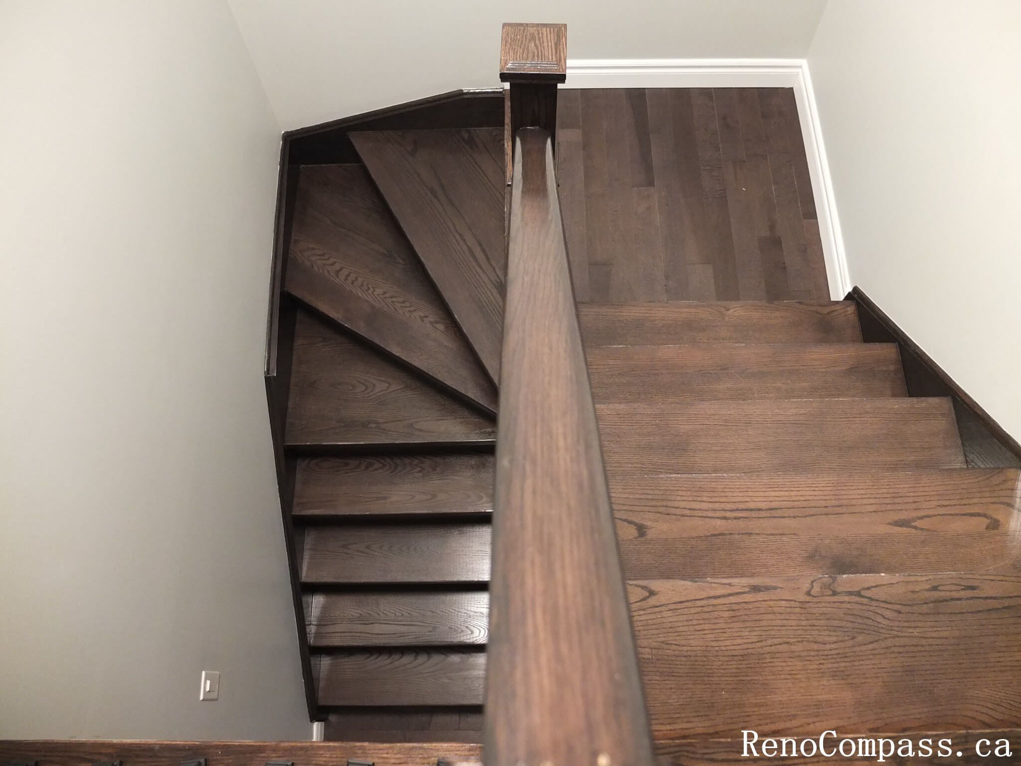 This Richmond Hill interior renovation showcases a modern staircase upgrade featuring dark hardwood flooring paired with custom black iron railings and solid wood posts. Completed by an experienced Toronto renovation company, the design enhances safety, durability, and visual elegance while creating a cohesive connection between floors. The refined railing details and warm wood tones add a sophisticated architectural element to the home’s interior.