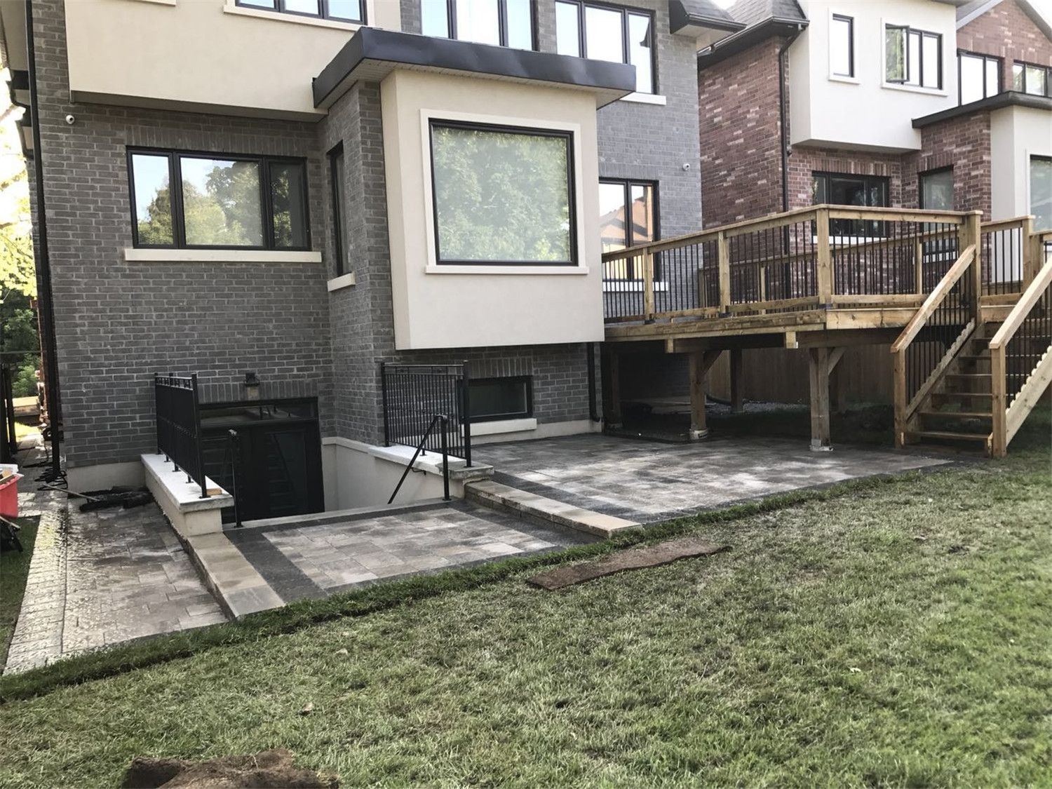 Toronto landscaping renovation featuring custom interlock patio steps and a retaining wall structure designed to create a multi-level backyard outdoor space. The durable paving stones and clean stone edging improve accessibility, drainage, and overall landscape functionality for a Toronto residential property.